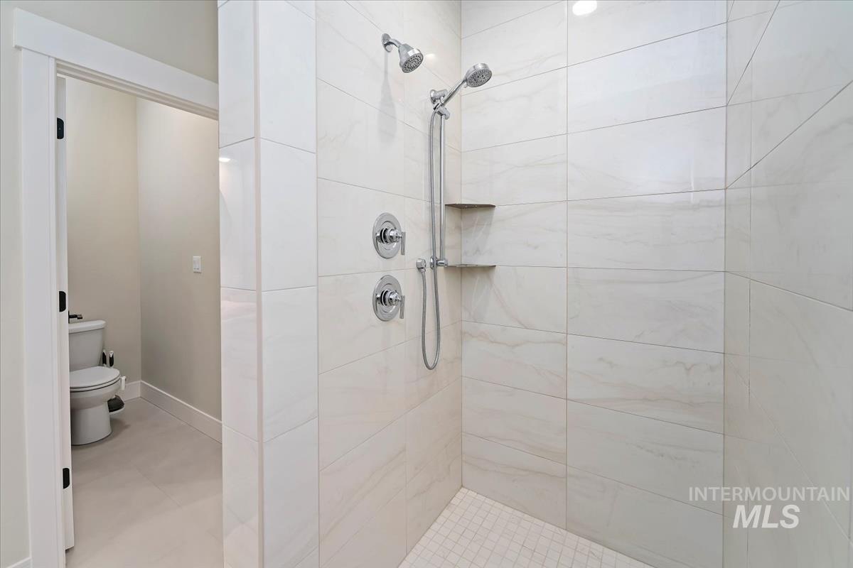 Full bath with a shower stall and toilet