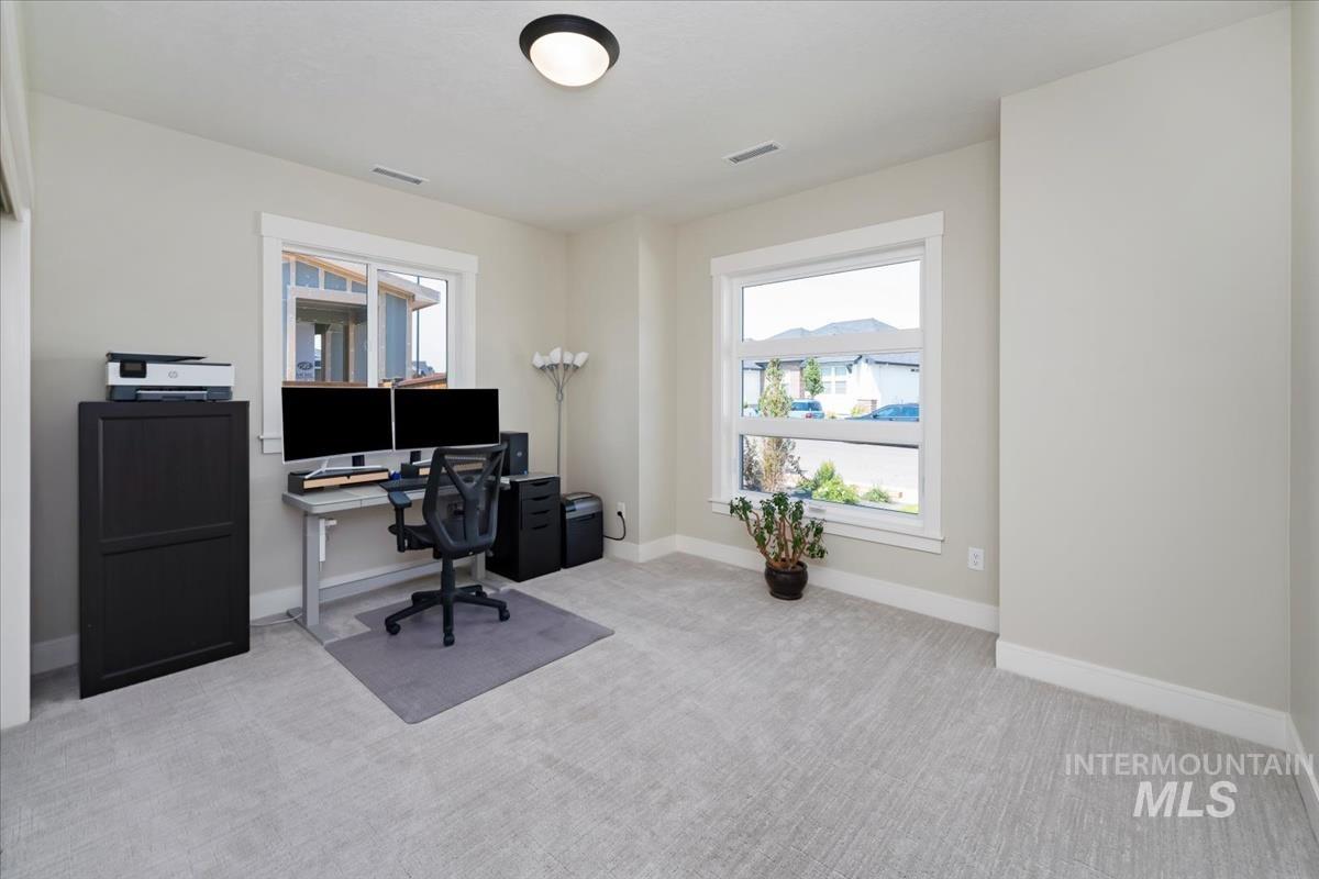 Office area with light carpet and baseboards