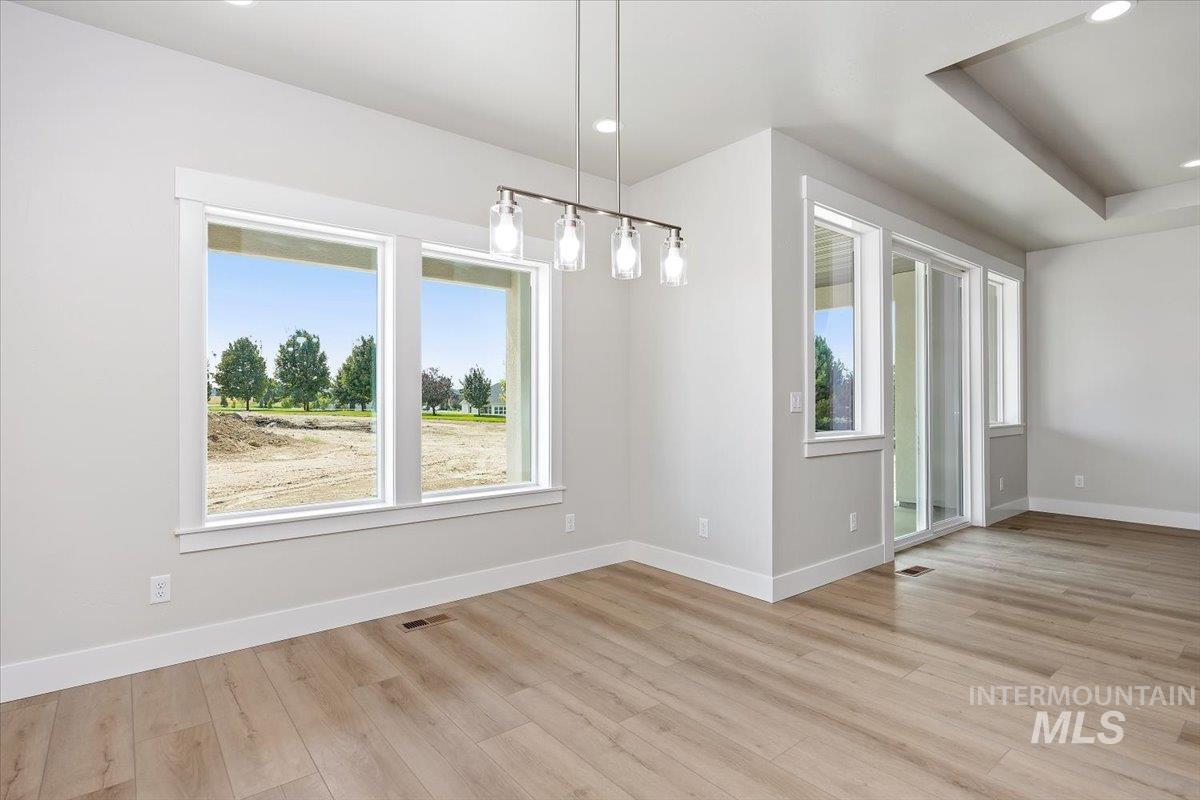 Unfurnished dining area with light wood finished floors and recessed lighting
