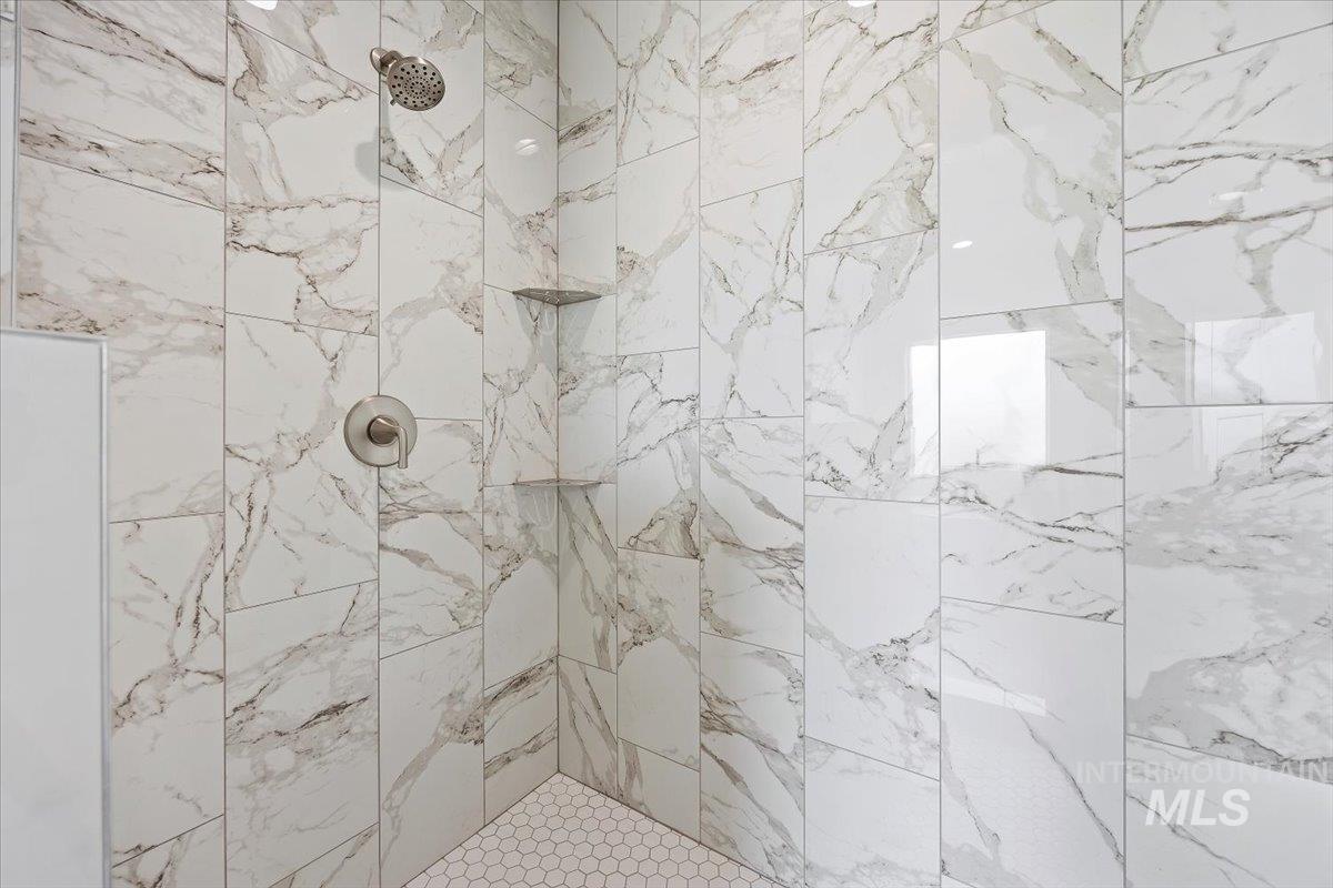 Full bath featuring a tile shower