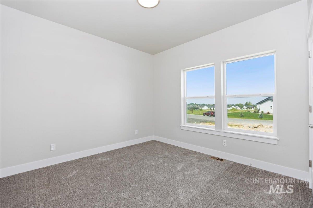 Carpeted empty room with baseboards
