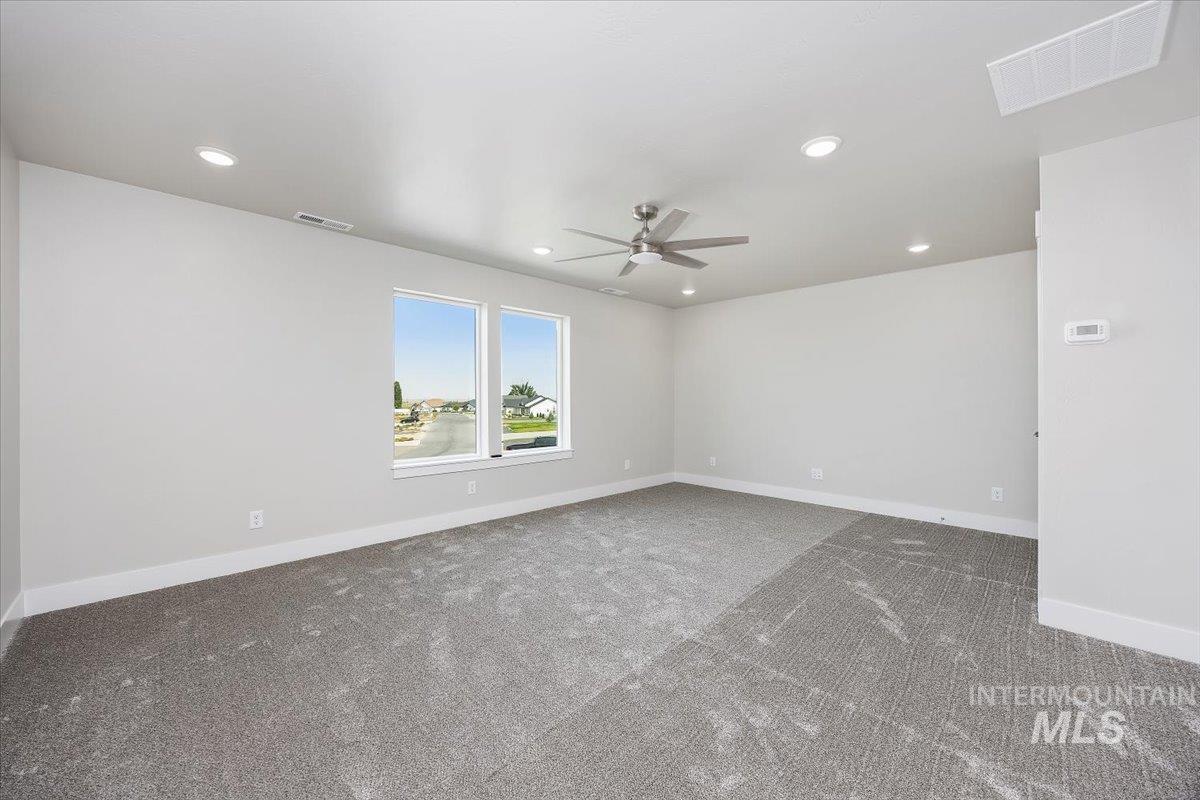 Carpeted spare room with recessed lighting and a ceiling fan