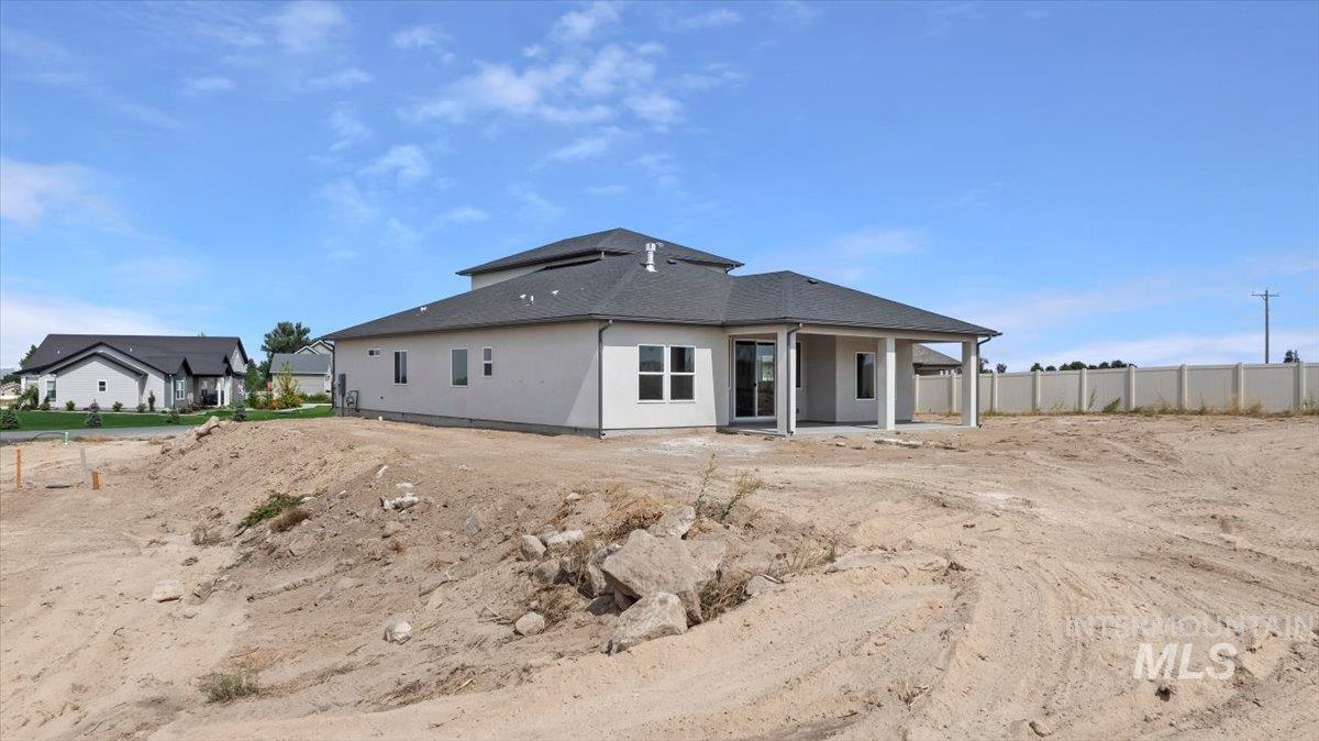Back of property with a patio area and stucco siding