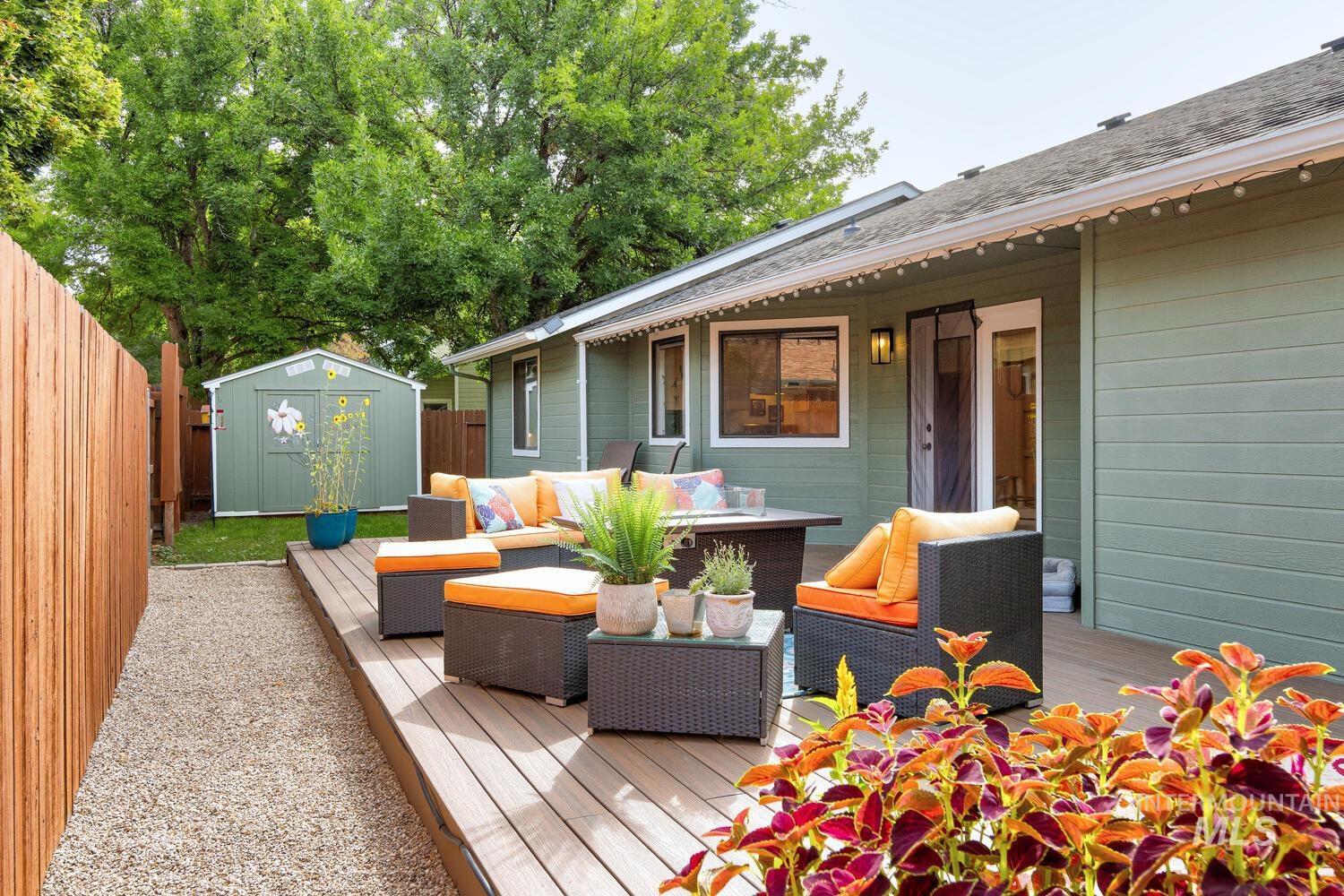 Deck with outdoor lounge area and a shed