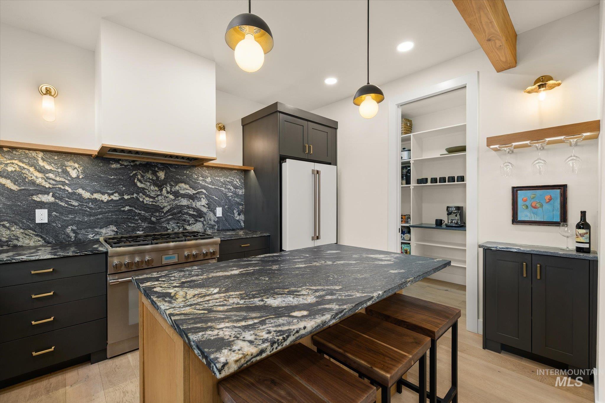 Kitchen featuring dark stone counters, light wood-style floors, open shelves, recessed lighting, and beamed ceiling