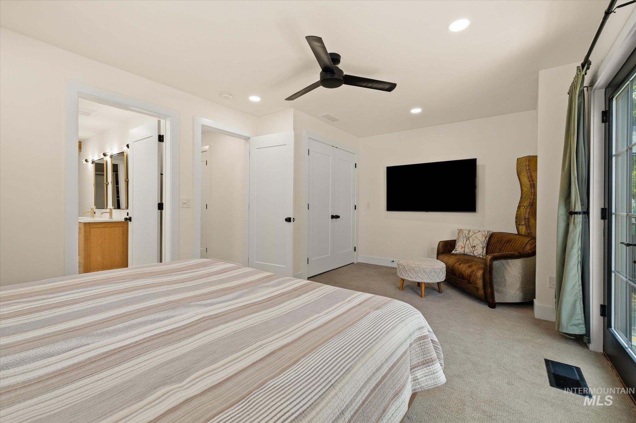 Bedroom with light colored carpet, recessed lighting, and ceiling fan