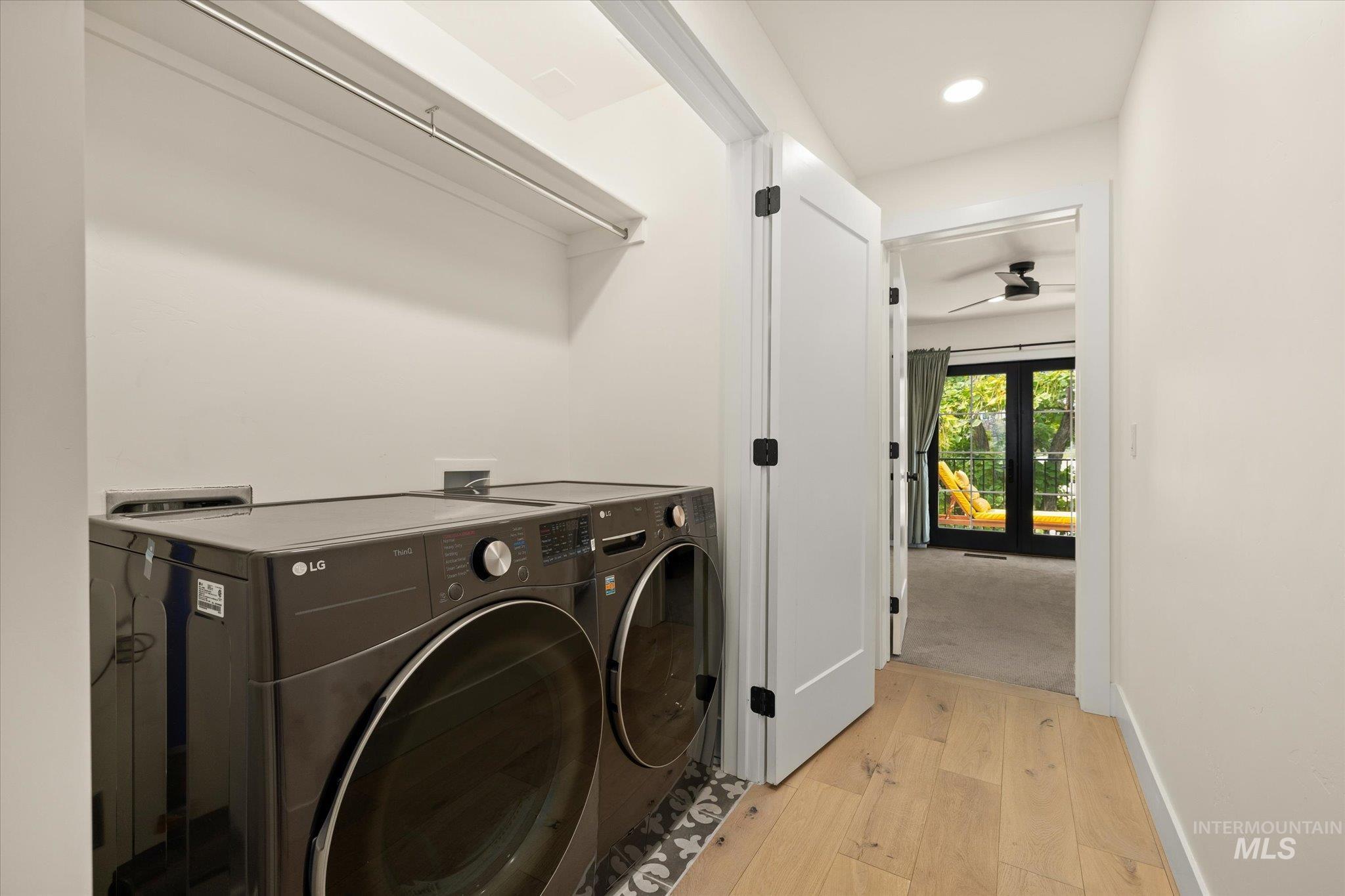 Laundry room with light wood finished floors, ceiling fan, recessed lighting, and washer and clothes dryer