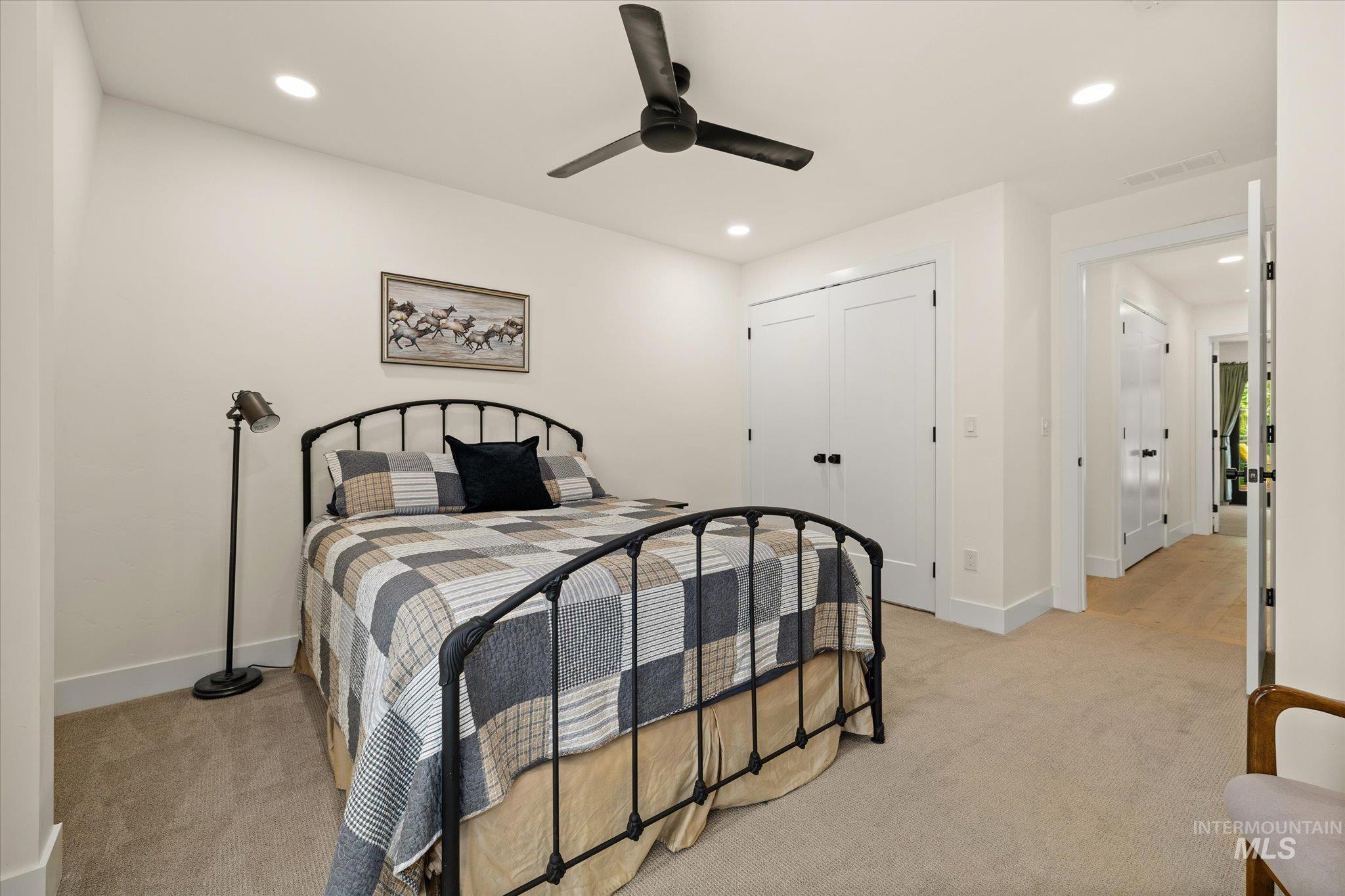 Bedroom with light carpet, ceiling fan, recessed lighting, and a closet