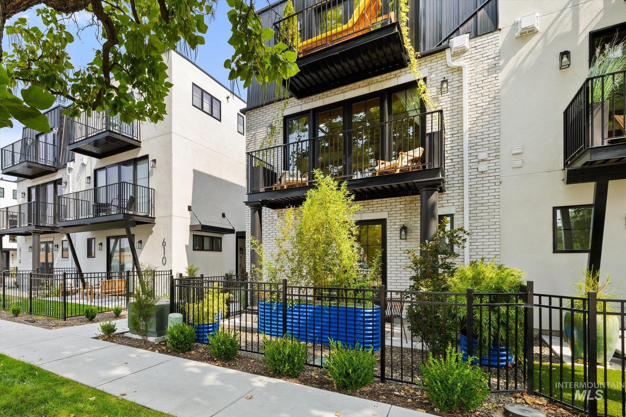 View of building exterior featuring a fenced front yard