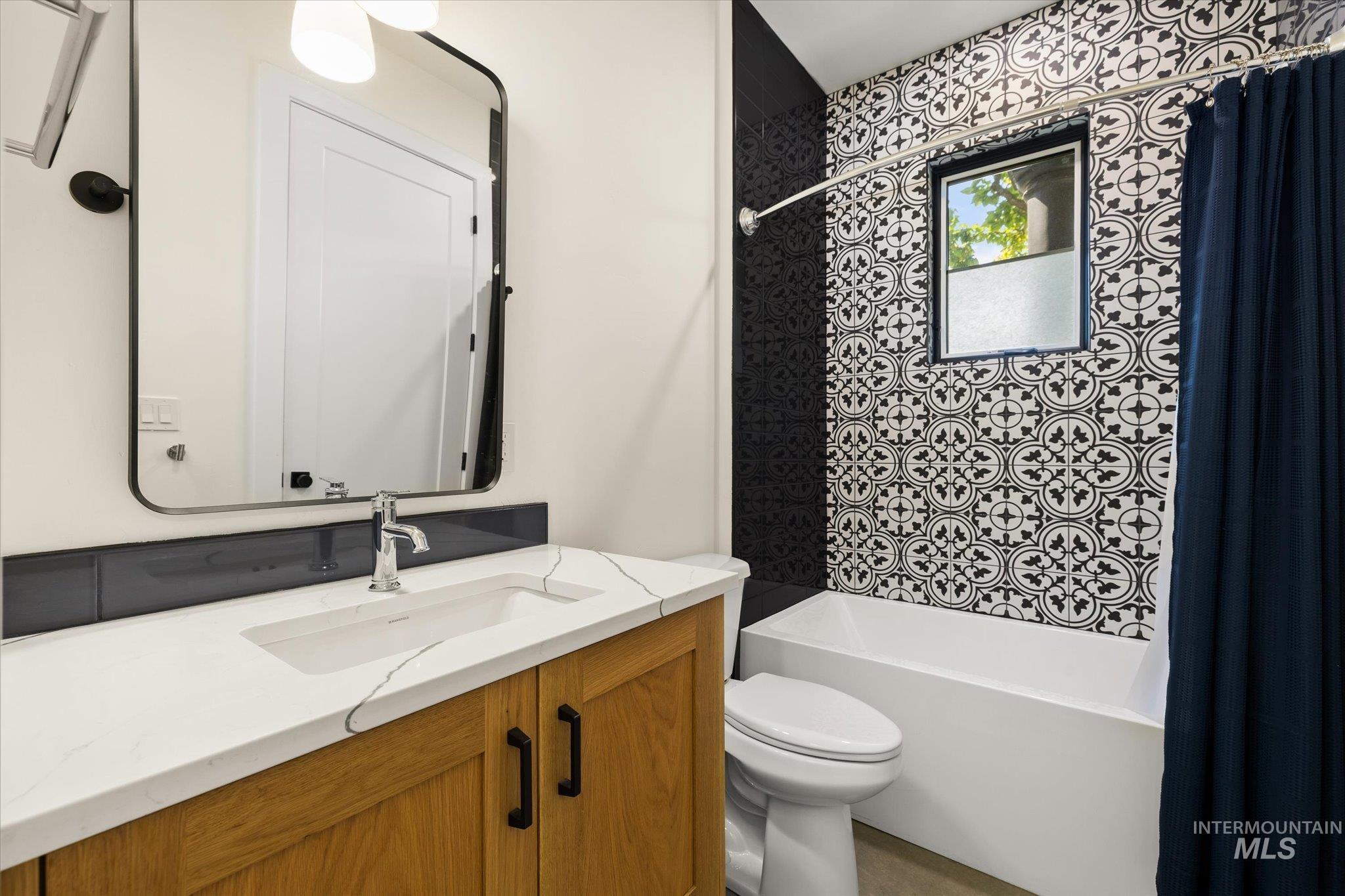 Full bathroom with vanity and shower / bath combo