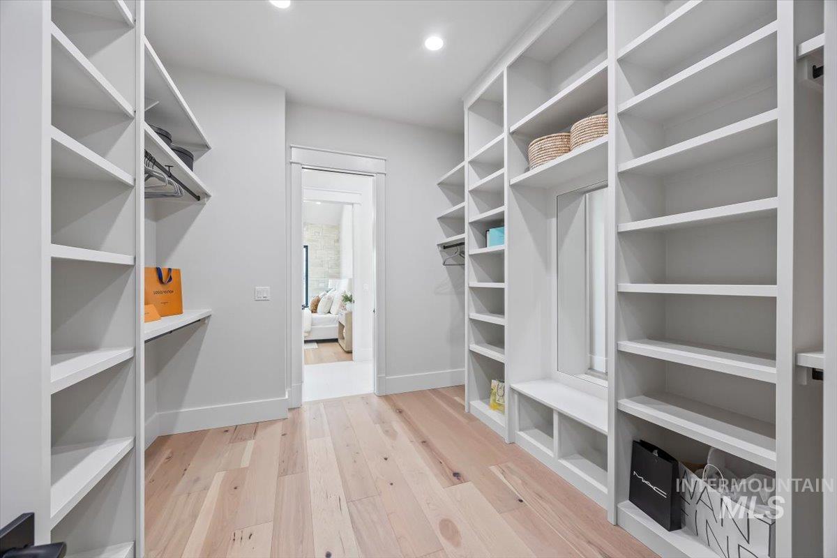 Walk in closet featuring wood finished floors