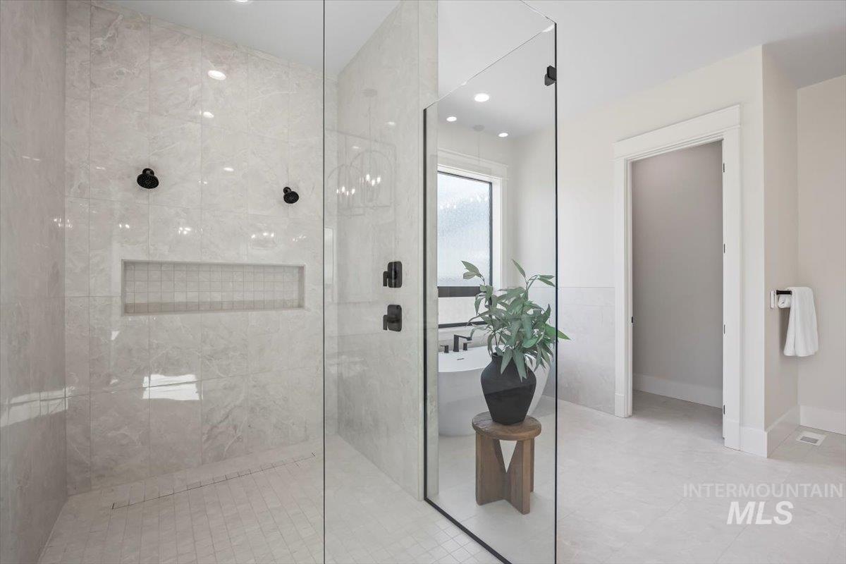 Full bathroom featuring a walk in shower, recessed lighting, and a freestanding bath