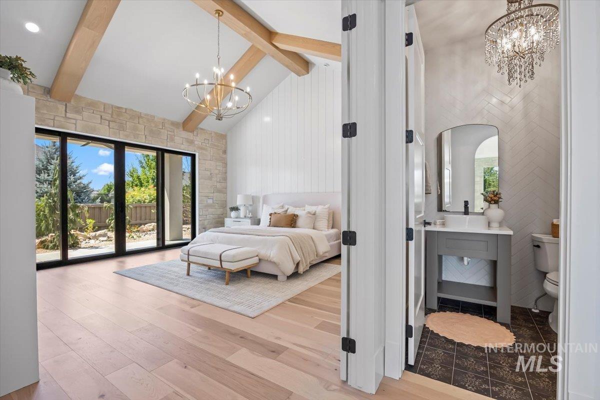 Bedroom featuring a chandelier, high vaulted ceiling, access to outside, beam ceiling, and wood finished floors