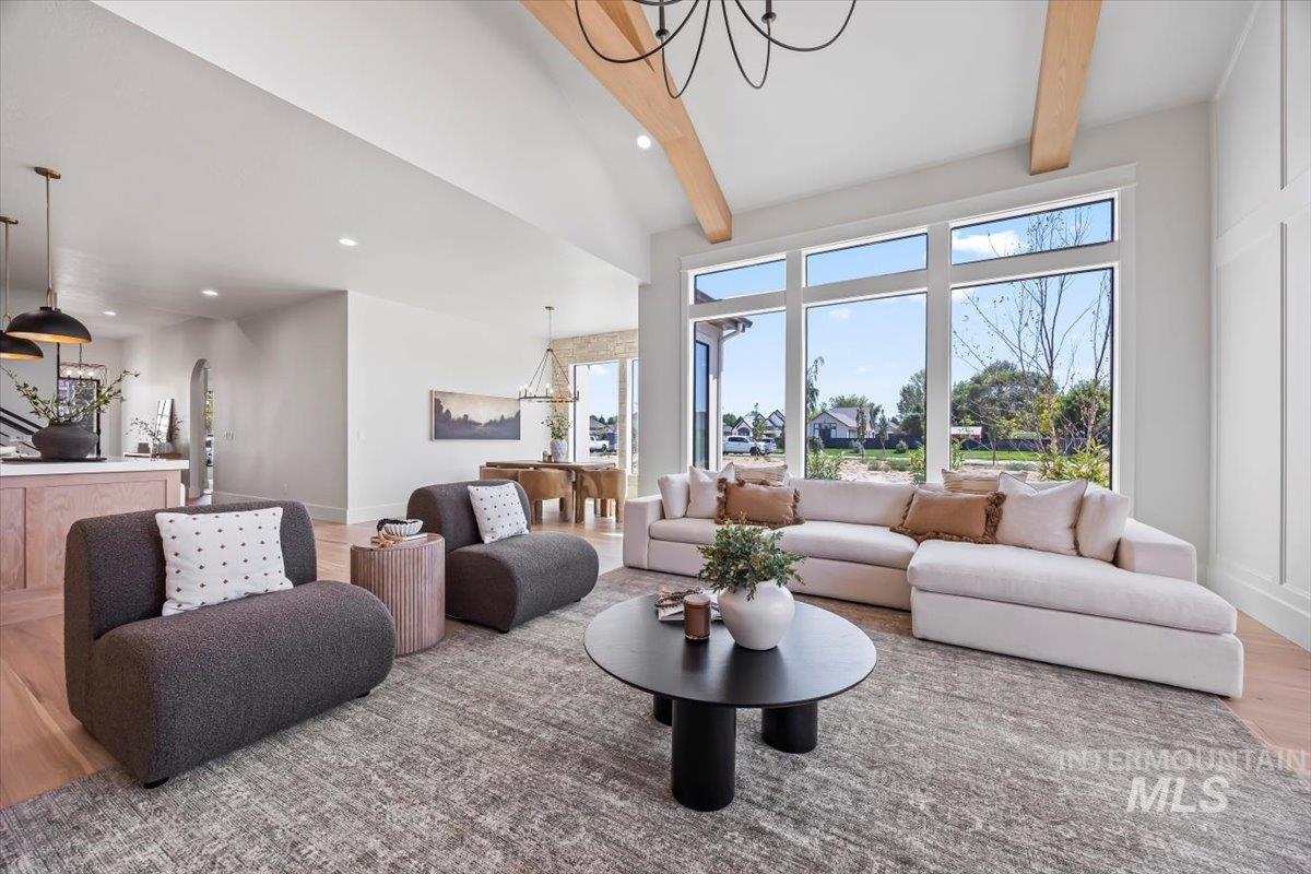 Living area with wood finished floors, a chandelier, and recessed lighting