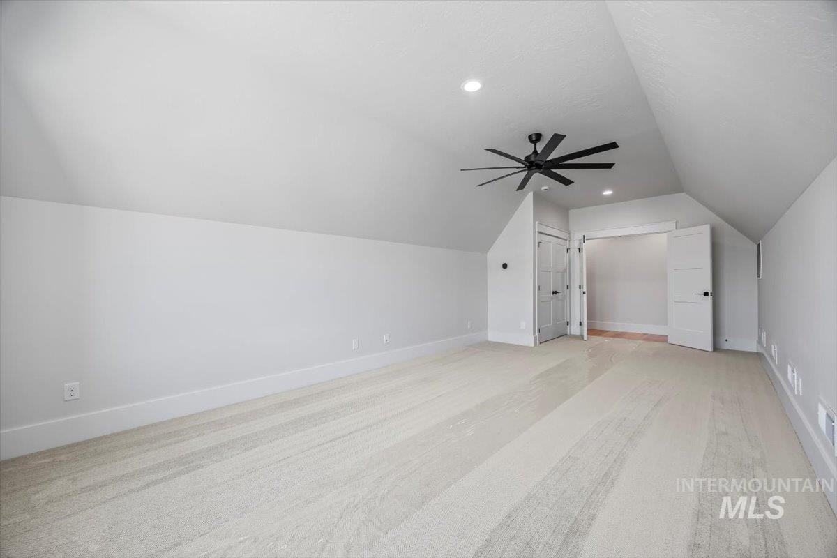Bonus room featuring vaulted ceiling, light carpet, a ceiling fan, and recessed lighting