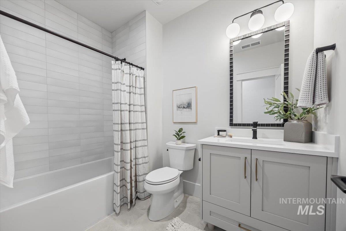 Full bathroom with vanity and shower / tub combo with curtain