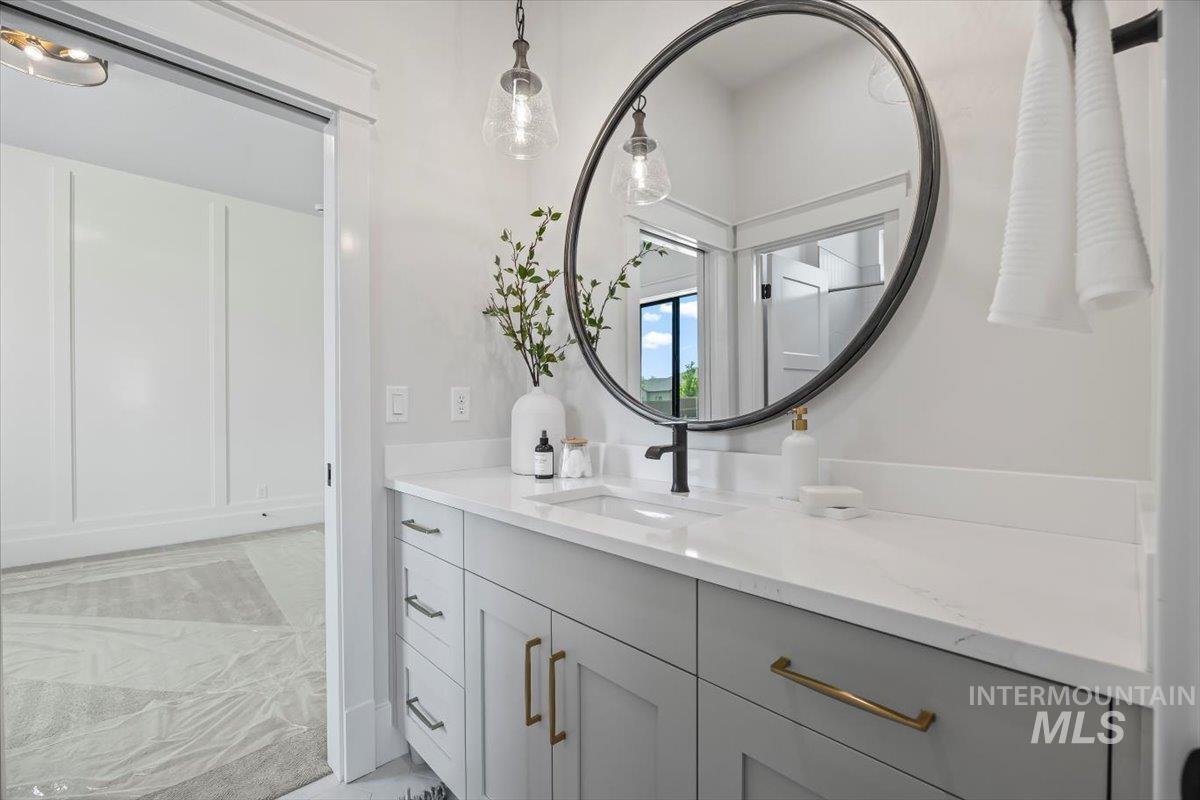 Bathroom with vanity and marble look tile flooring