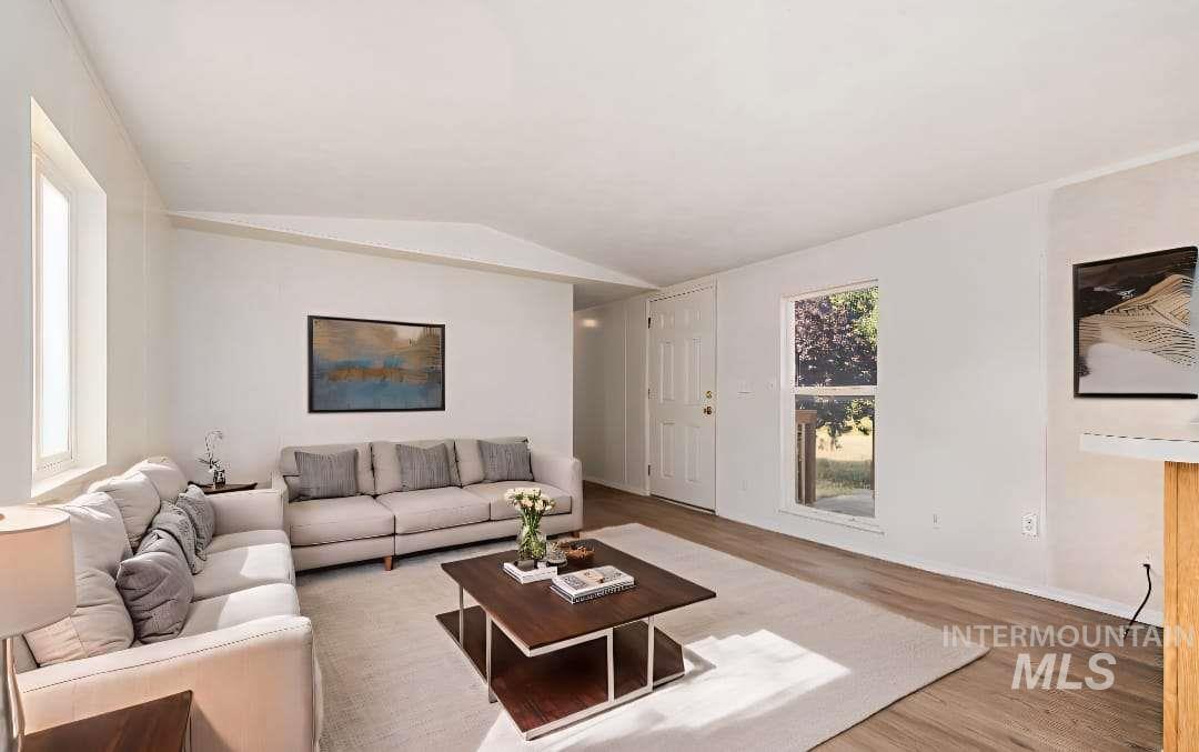 Living room with wood finished floors and vaulted ceiling