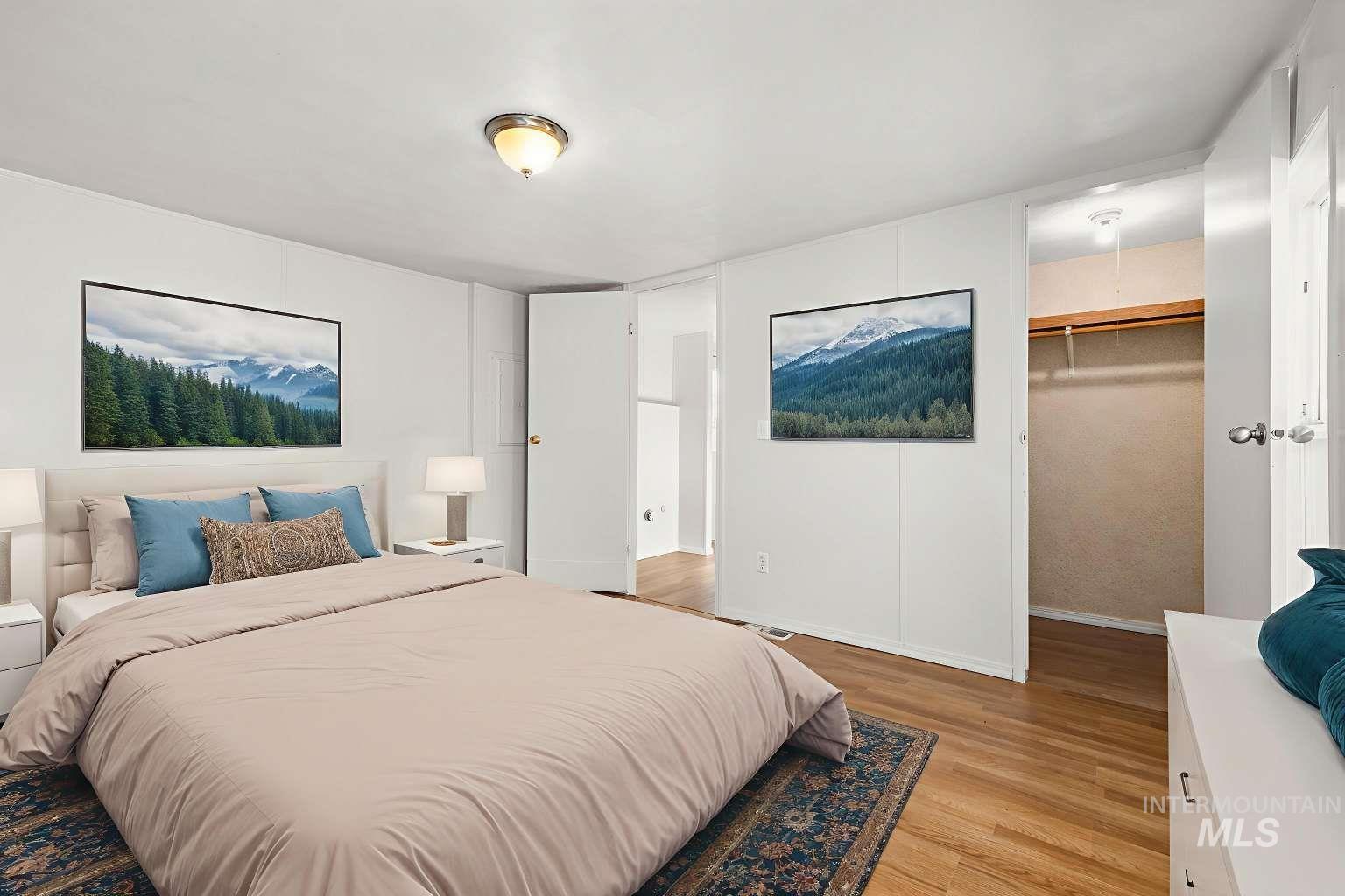 Bedroom featuring a spacious closet and light wood-style flooring