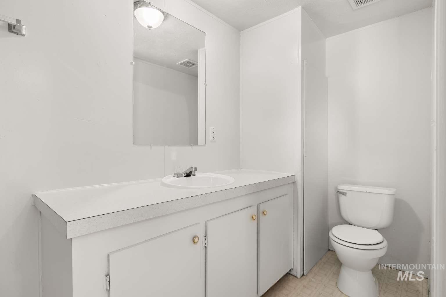 Bathroom with vanity and light floors