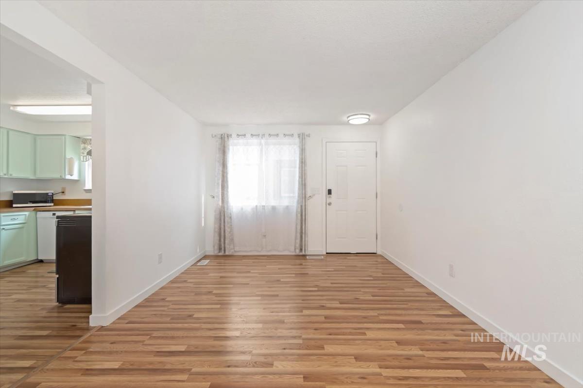 Foyer featuring light wood-style floors and baseboards
