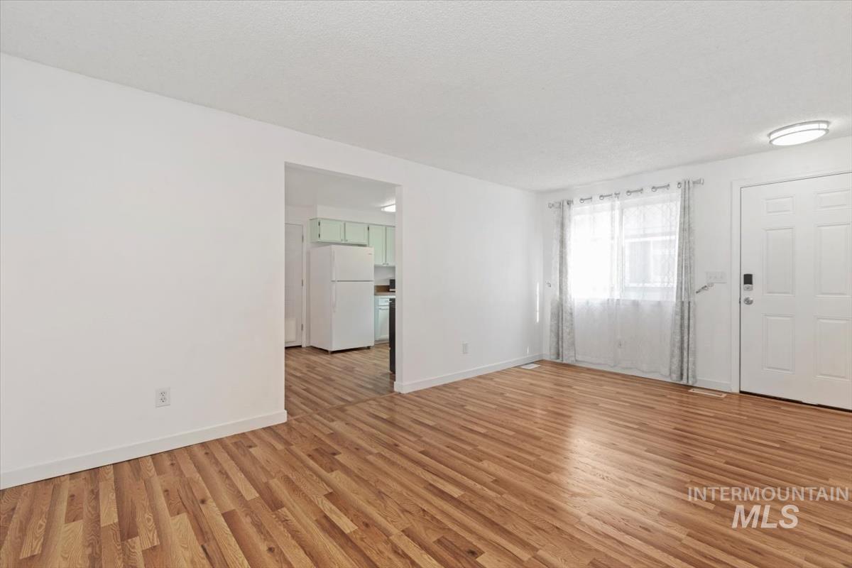 Spare room with light wood-style flooring and baseboards