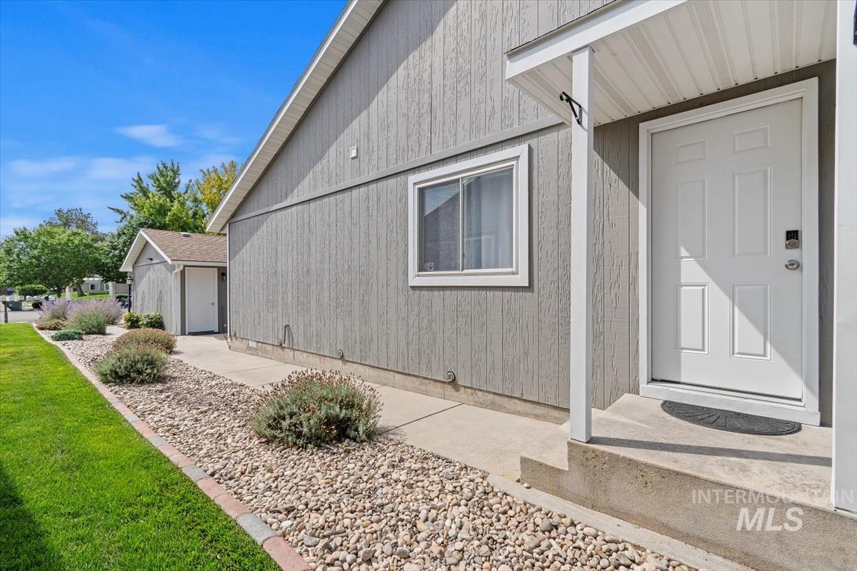 Entrance to property with a lawn