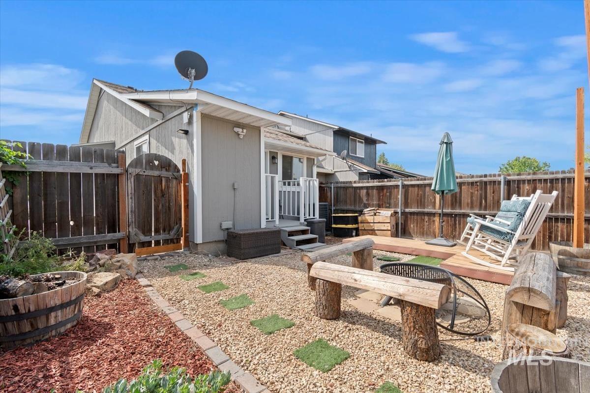 Back of property with a fenced backyard, a sunroom, and a deck