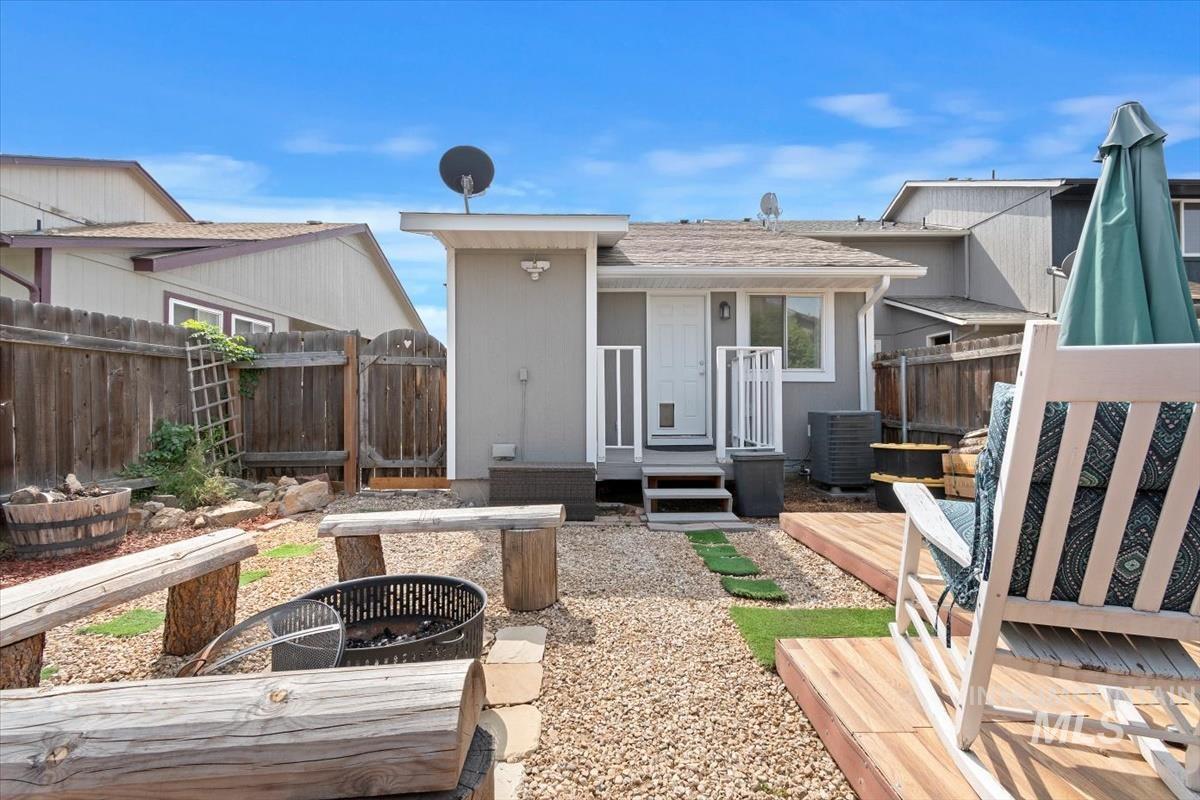 Back of property featuring a deck and a fire pit