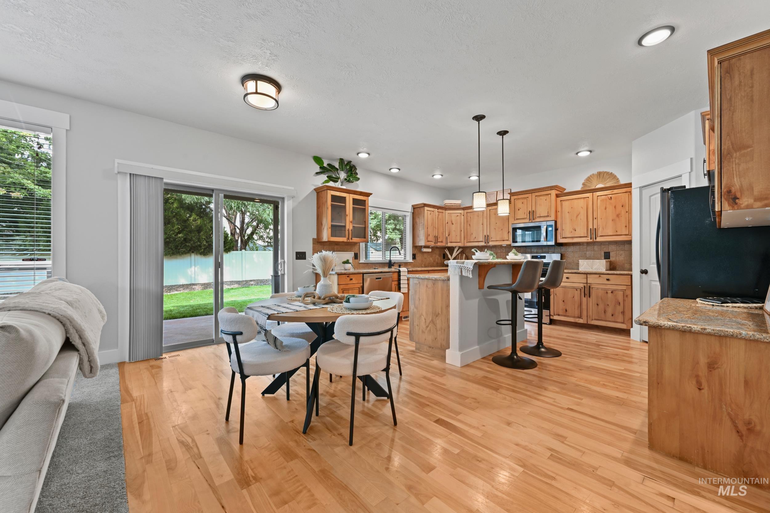 Dining space featuring light wood-type flooring and recessed lighting