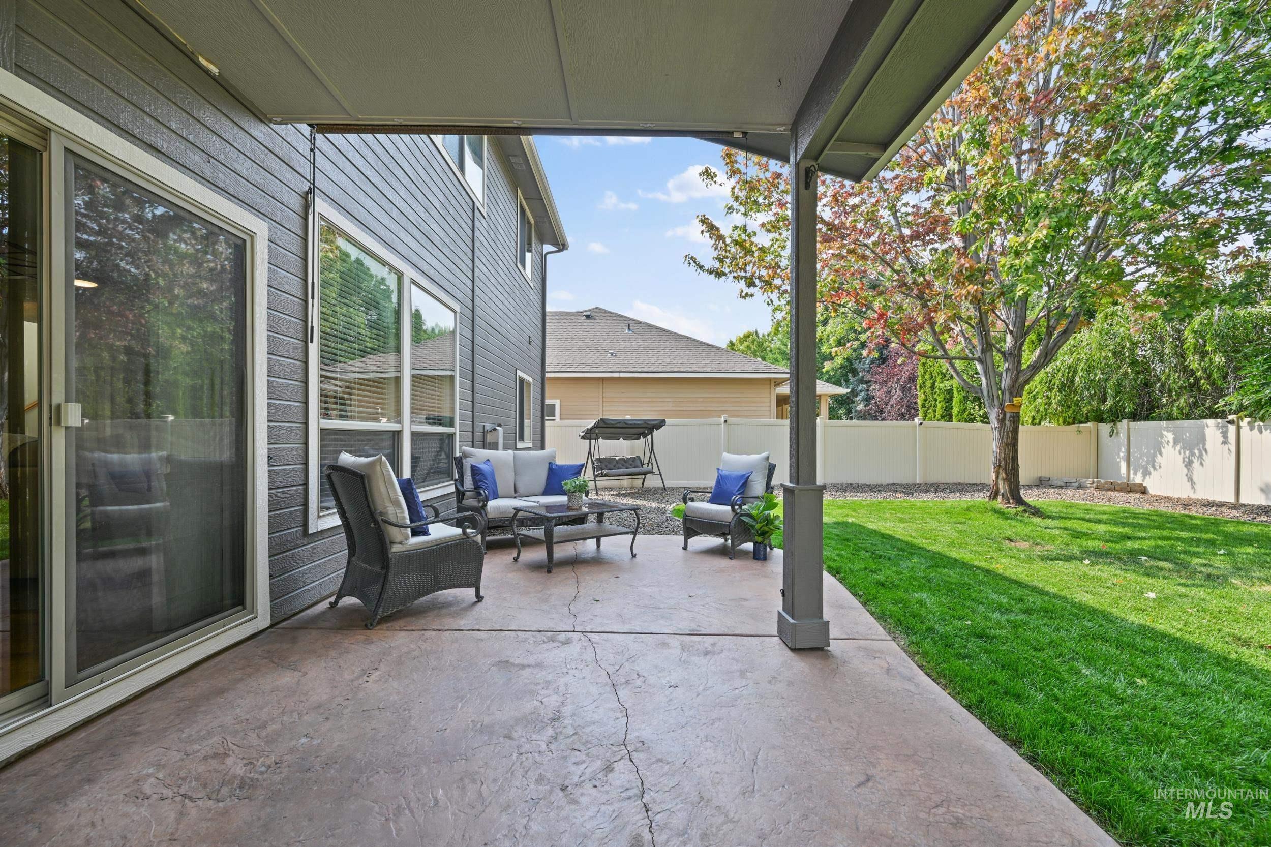 Fenced backyard with a patio area and an outdoor living space