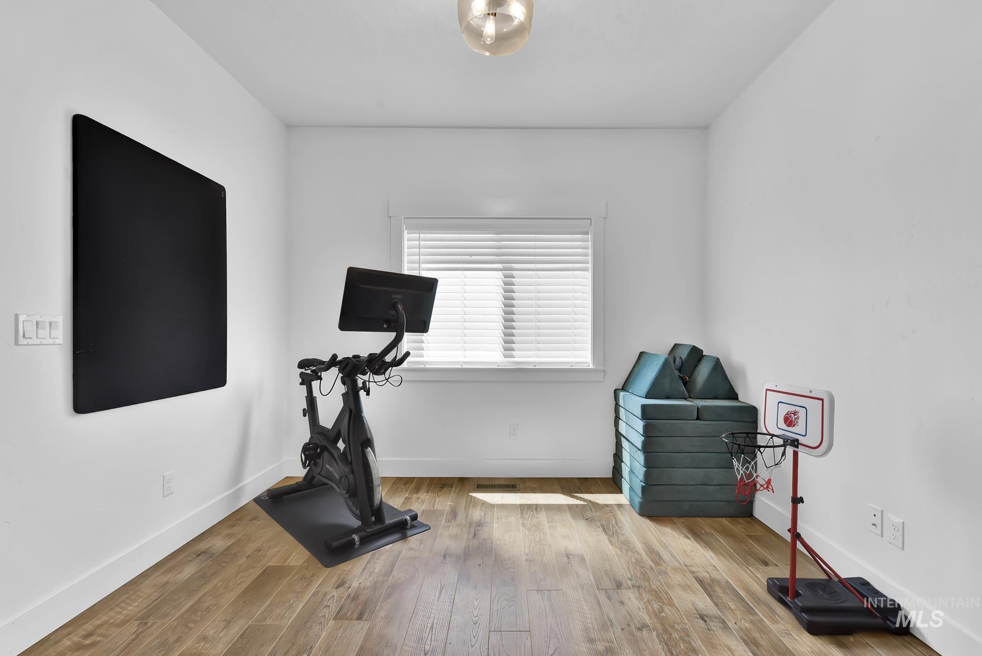 Office featuring hardwood / wood-style flooring and baseboards