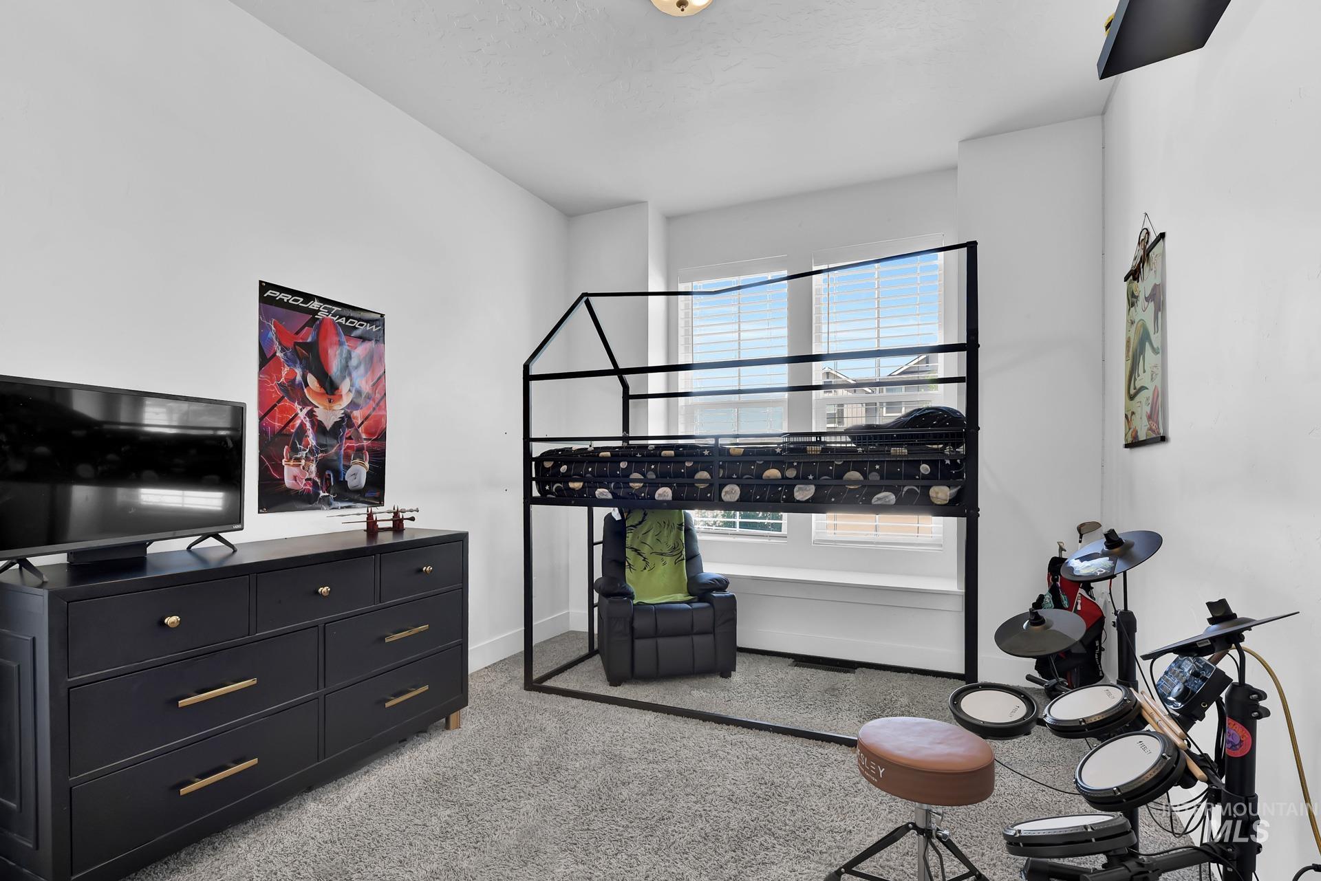 Bedroom featuring light colored carpet and baseboards
