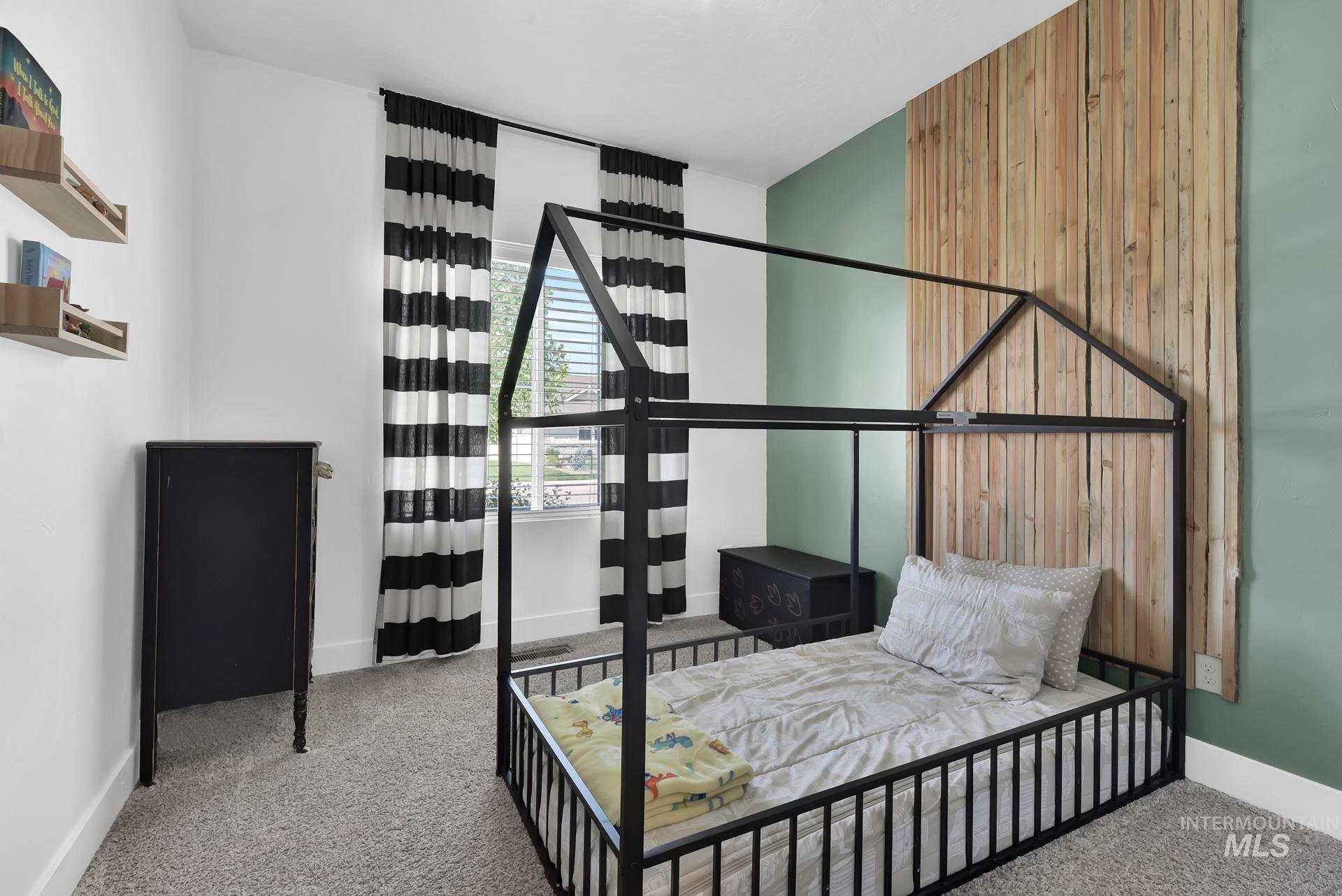 Carpeted bedroom featuring baseboards