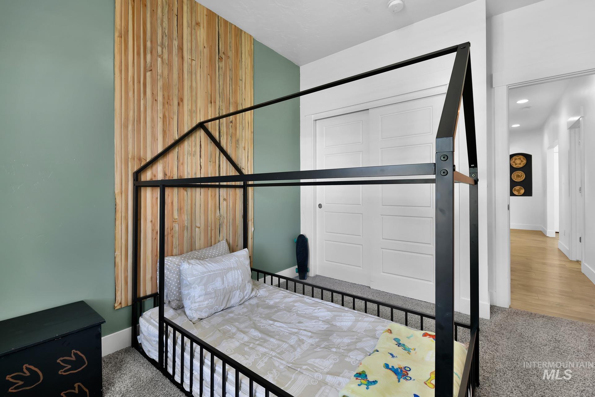 Bedroom featuring light colored carpet and baseboards