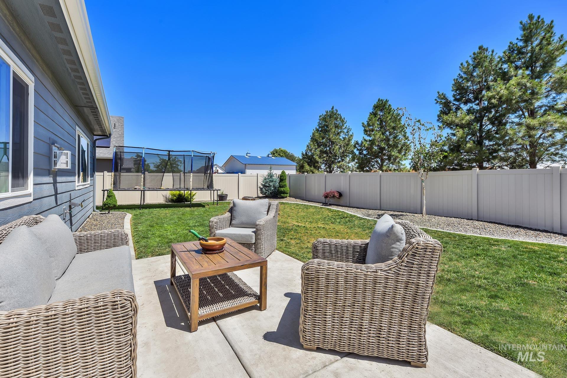 Fenced backyard with a patio and outdoor lounge area