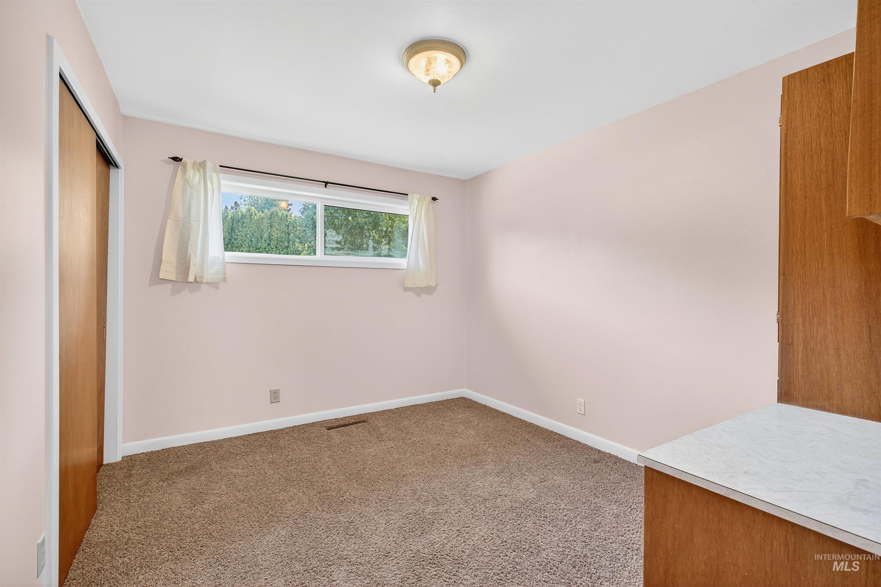 Unfurnished bedroom with carpet flooring and a closet