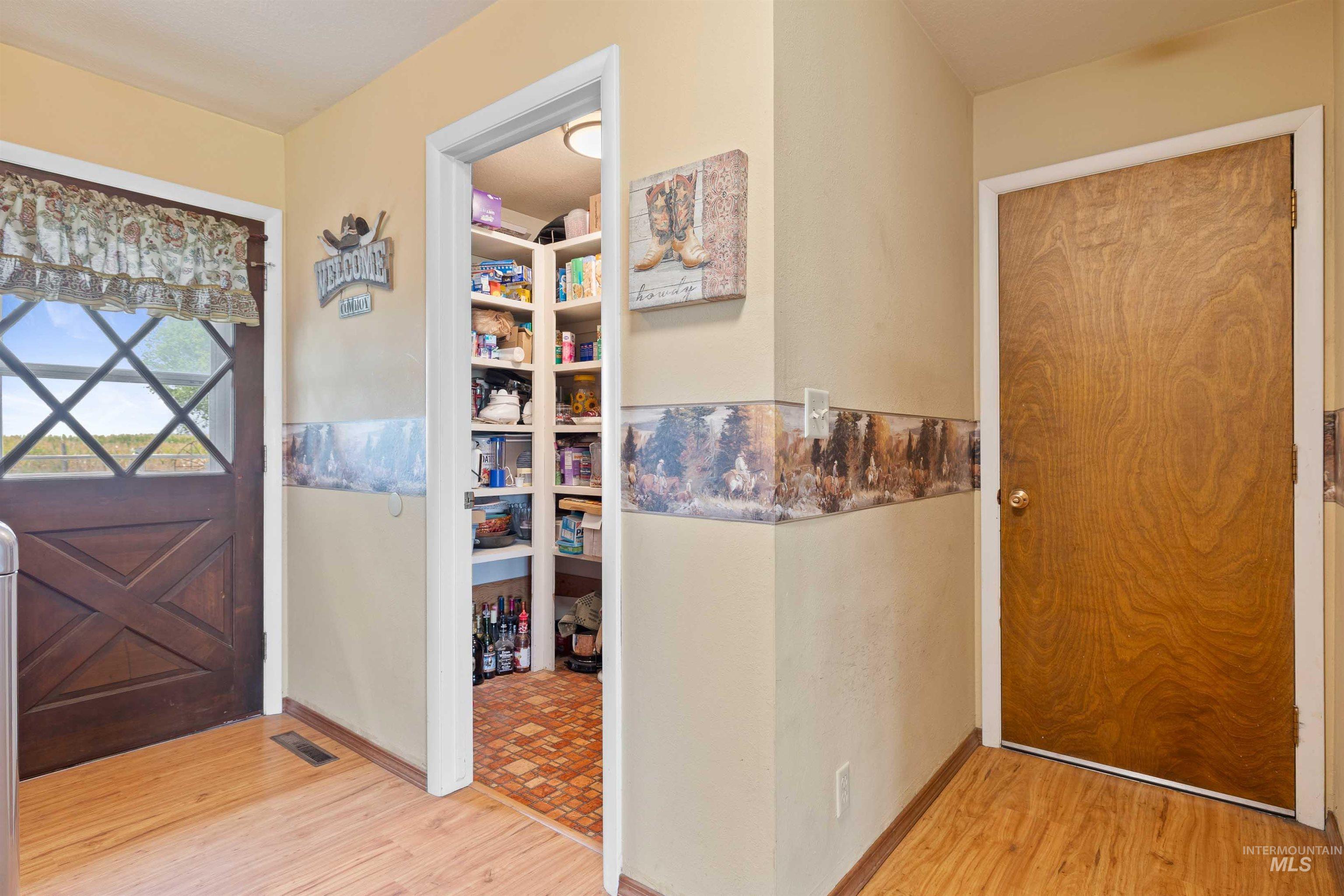 Back Door, pantry room, Foyer with light wood finished floors
