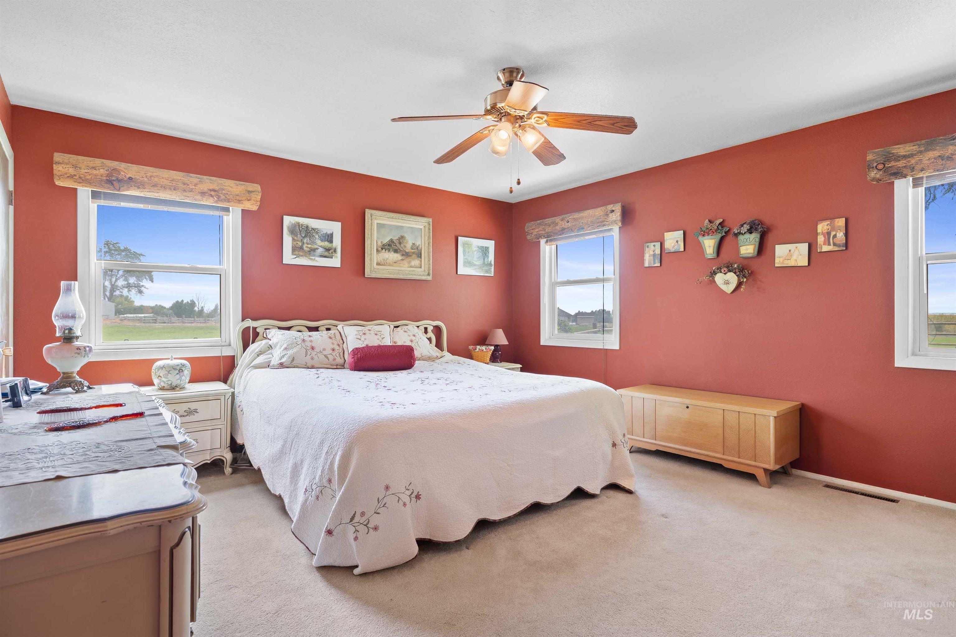 Bedroom featuring light carpet and a ceiling fan