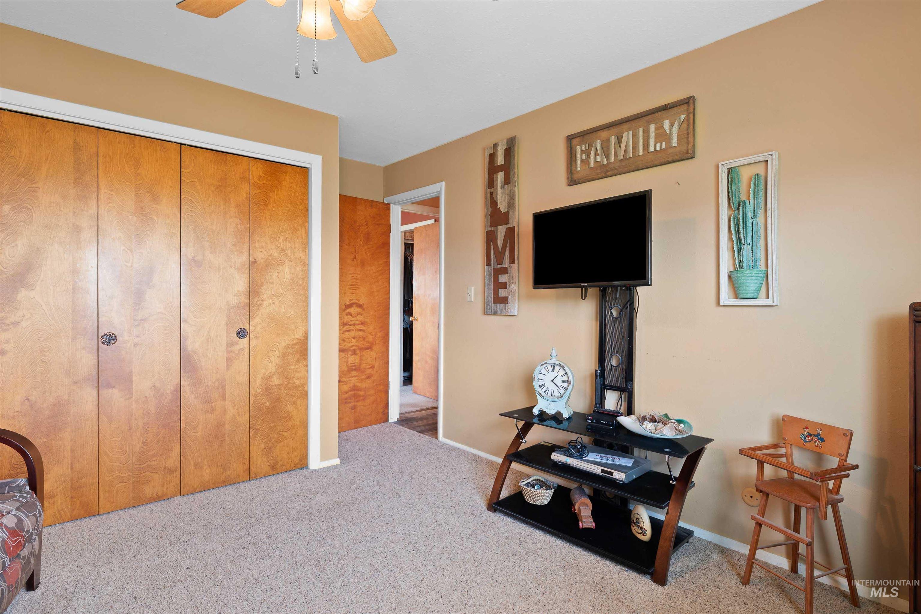 Bedroom featuring carpet floors, a closet, and ceiling fan