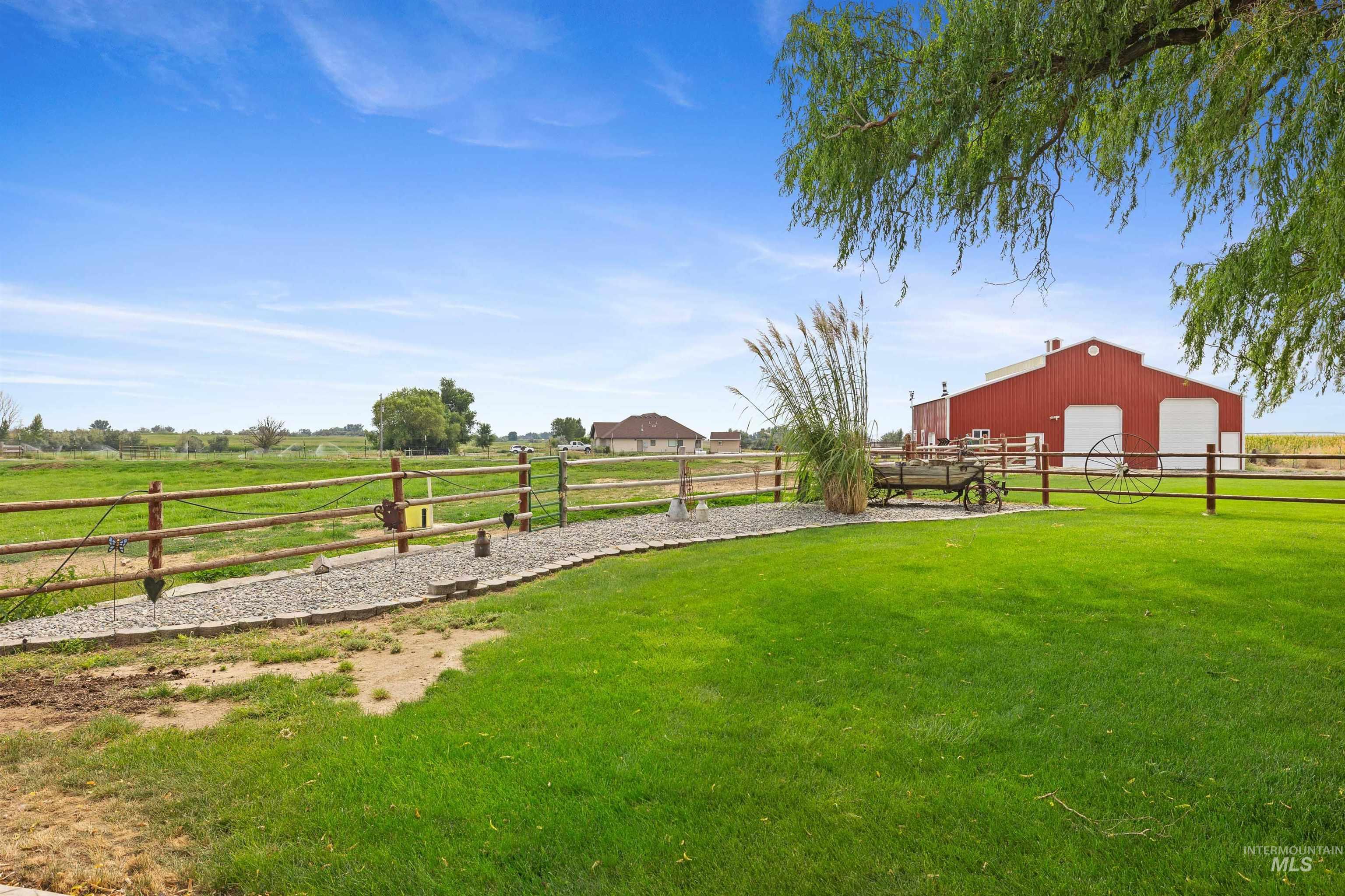 View of yard with an outbuilding, a detached garage, and a view of rural / pastoral area