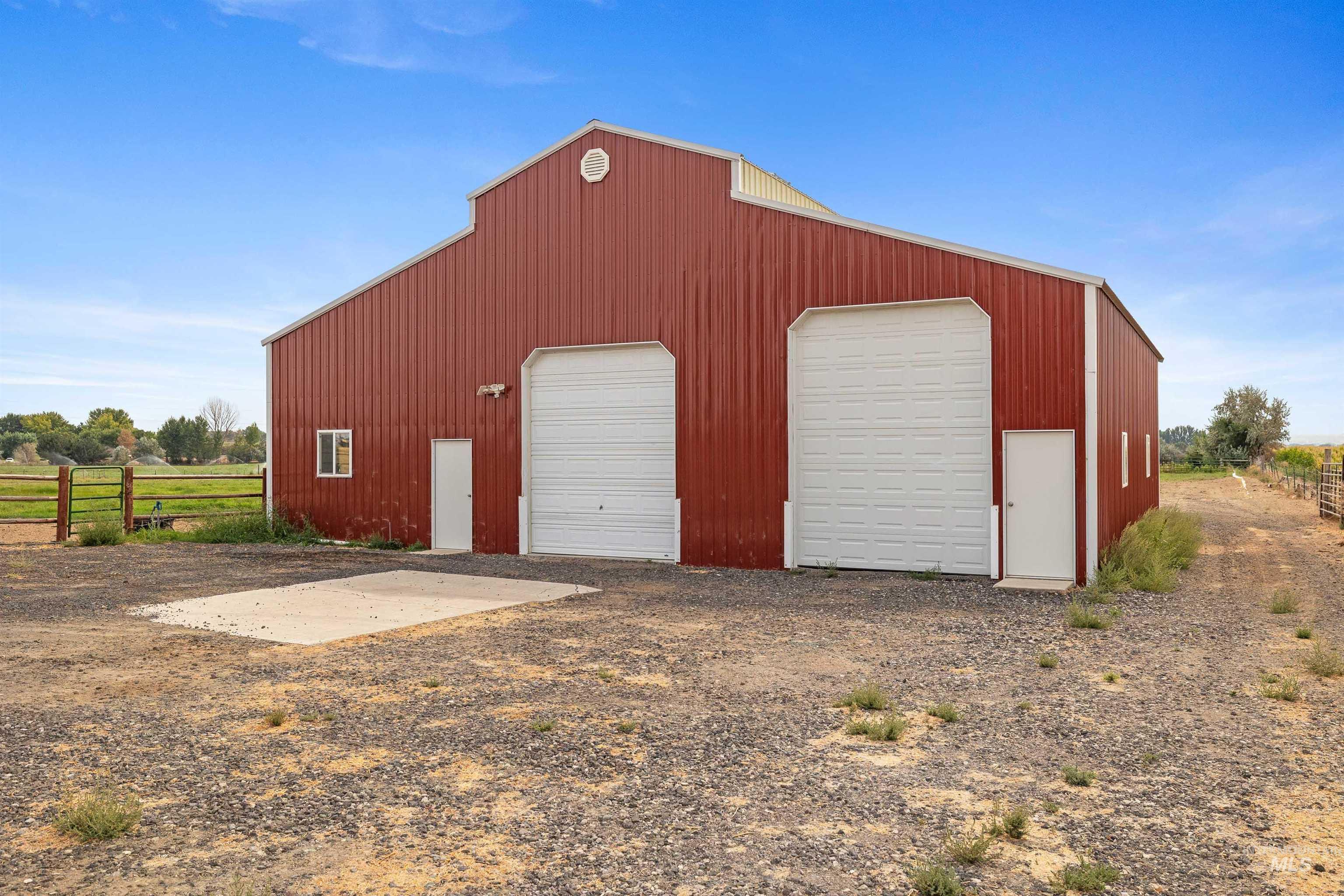 Detached garage featuring a rural view