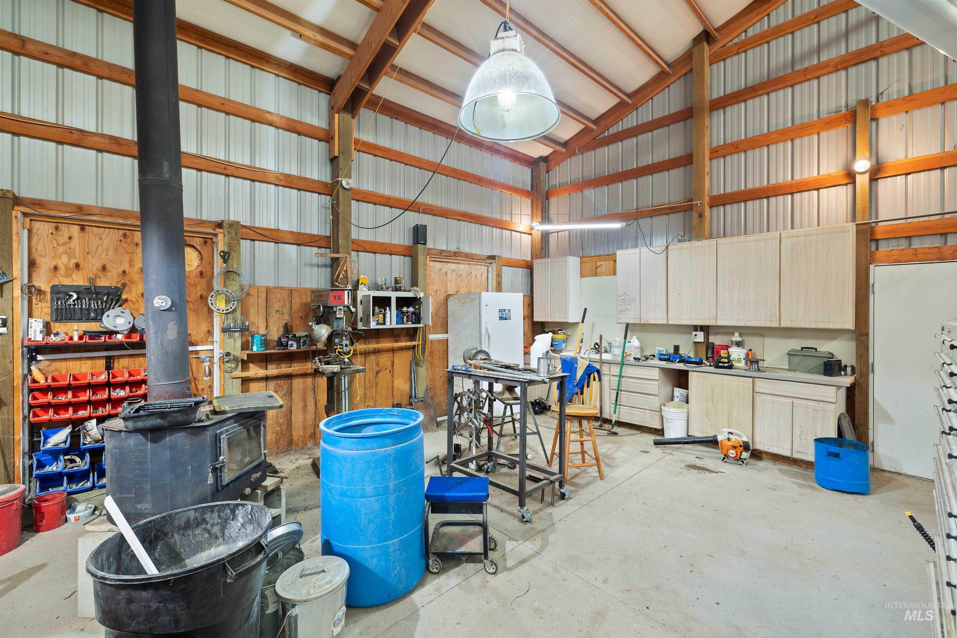 Garage featuring metal wall and a wood stove