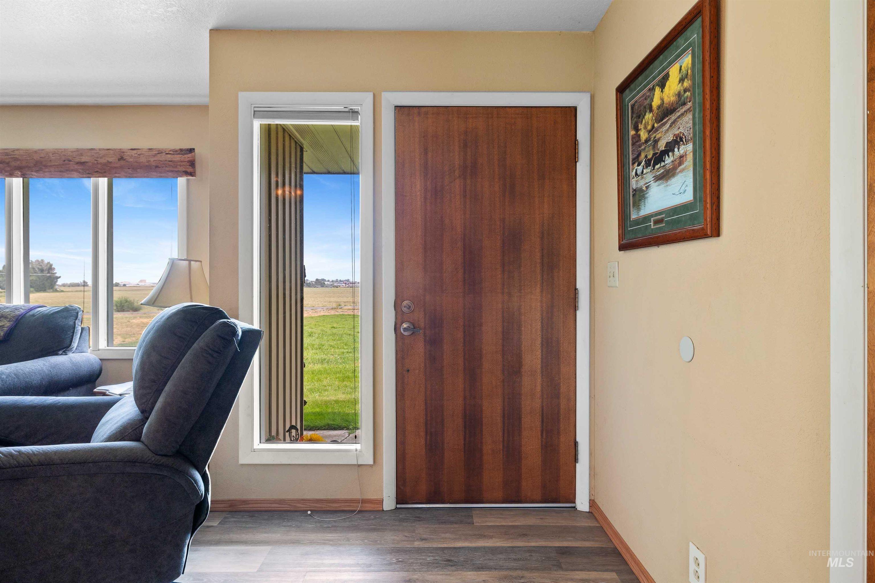 Entryway with wood finished floors and baseboards