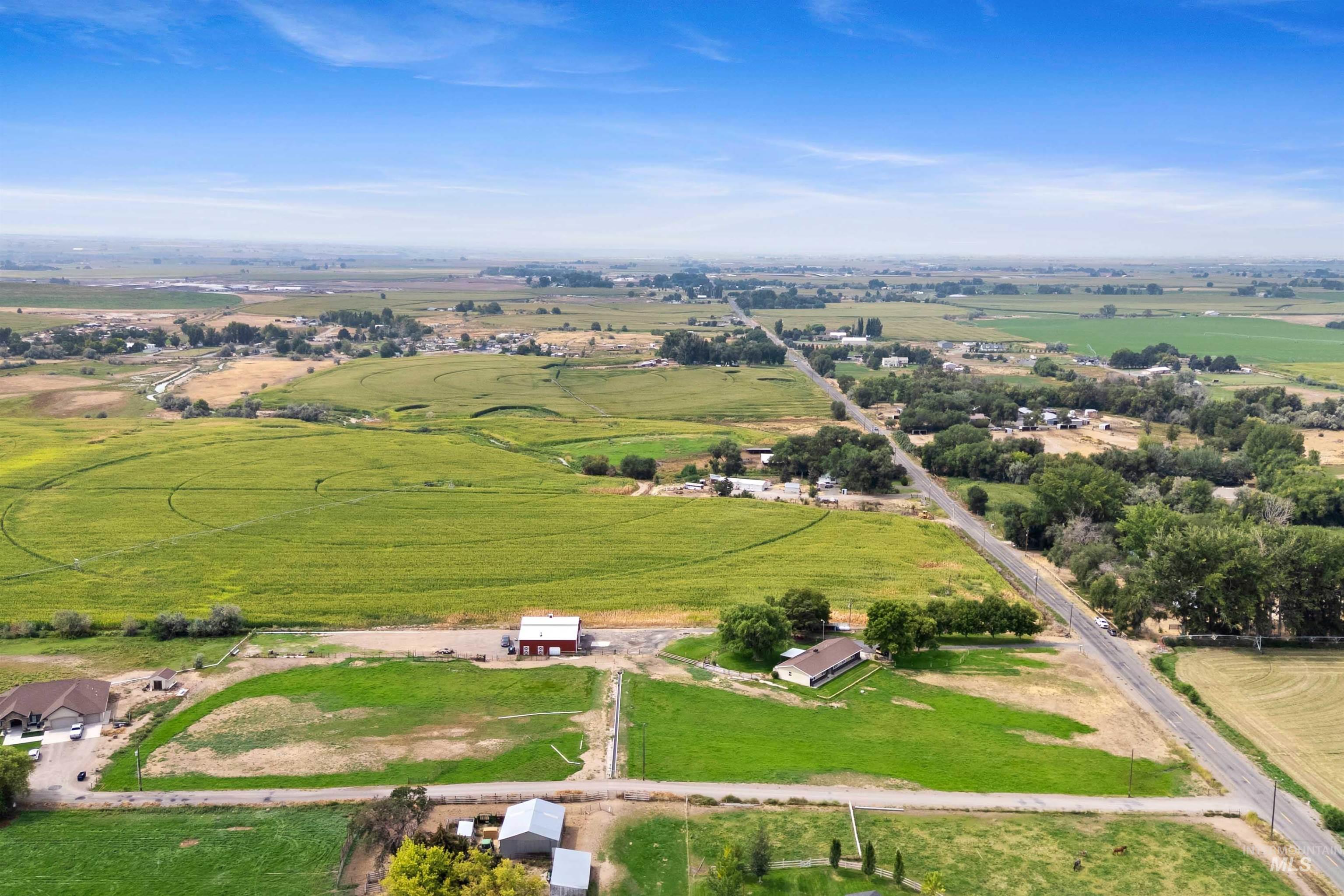 Aerial view of property and surrounding area with rural landscape
