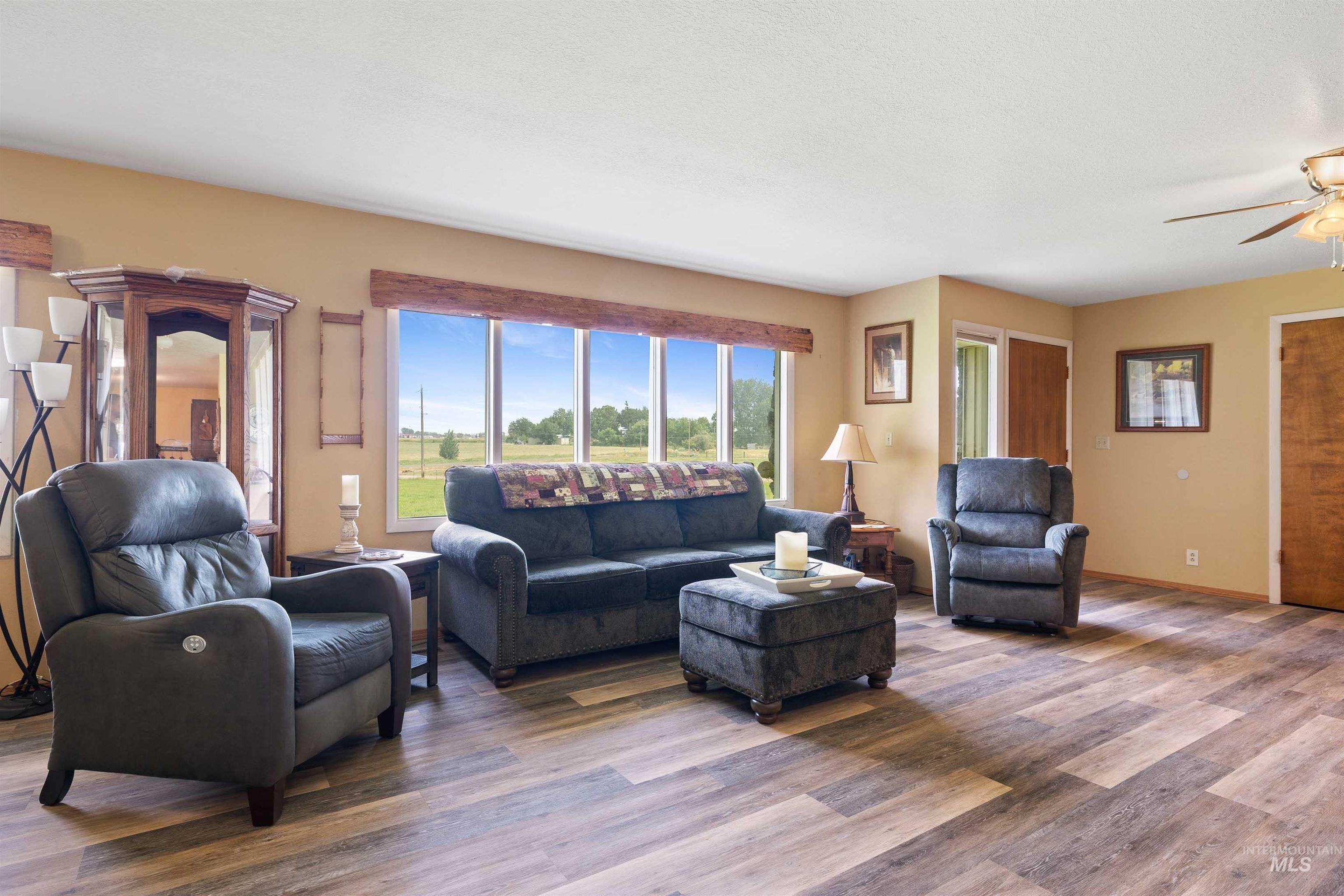 Living area with wood finished floors and ceiling fan