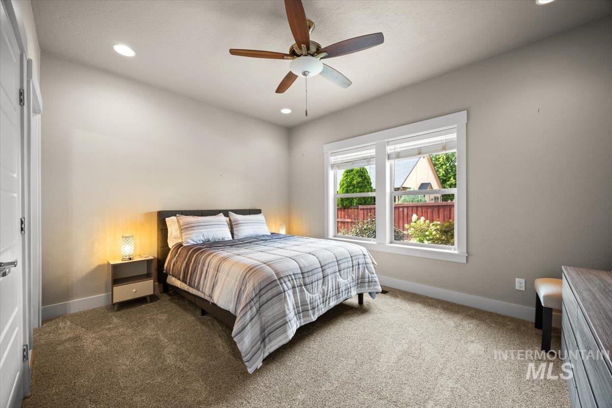 Bedroom with carpet, recessed lighting, and a ceiling fan