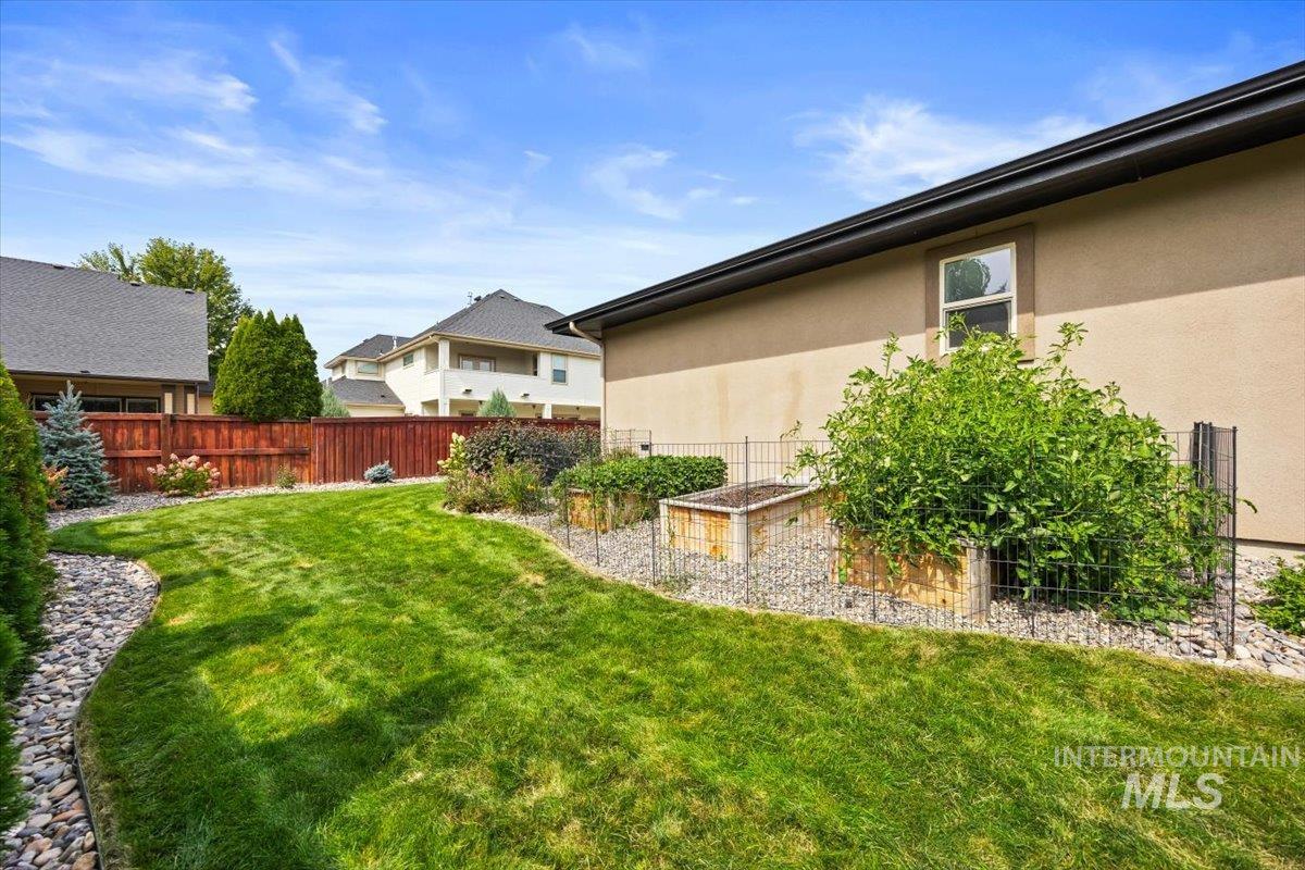 Fenced backyard with a vegetable garden