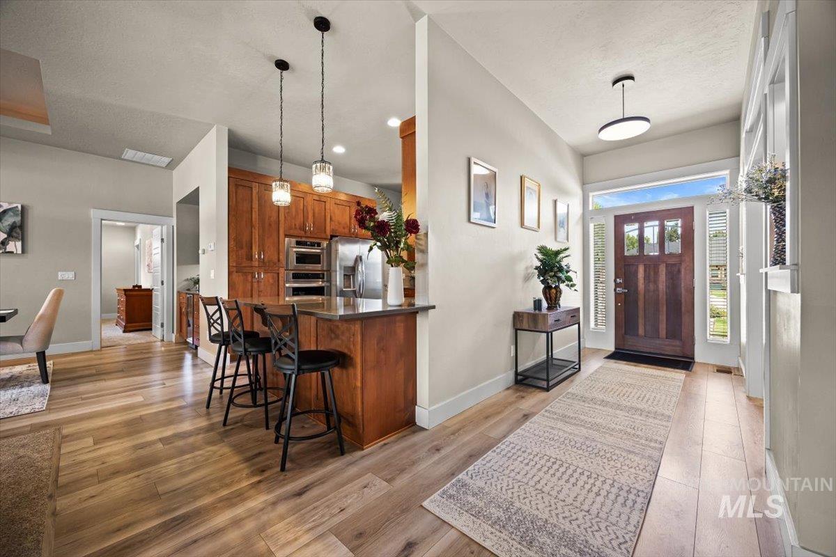 Entrance foyer with light wood-style floors and recessed lighting