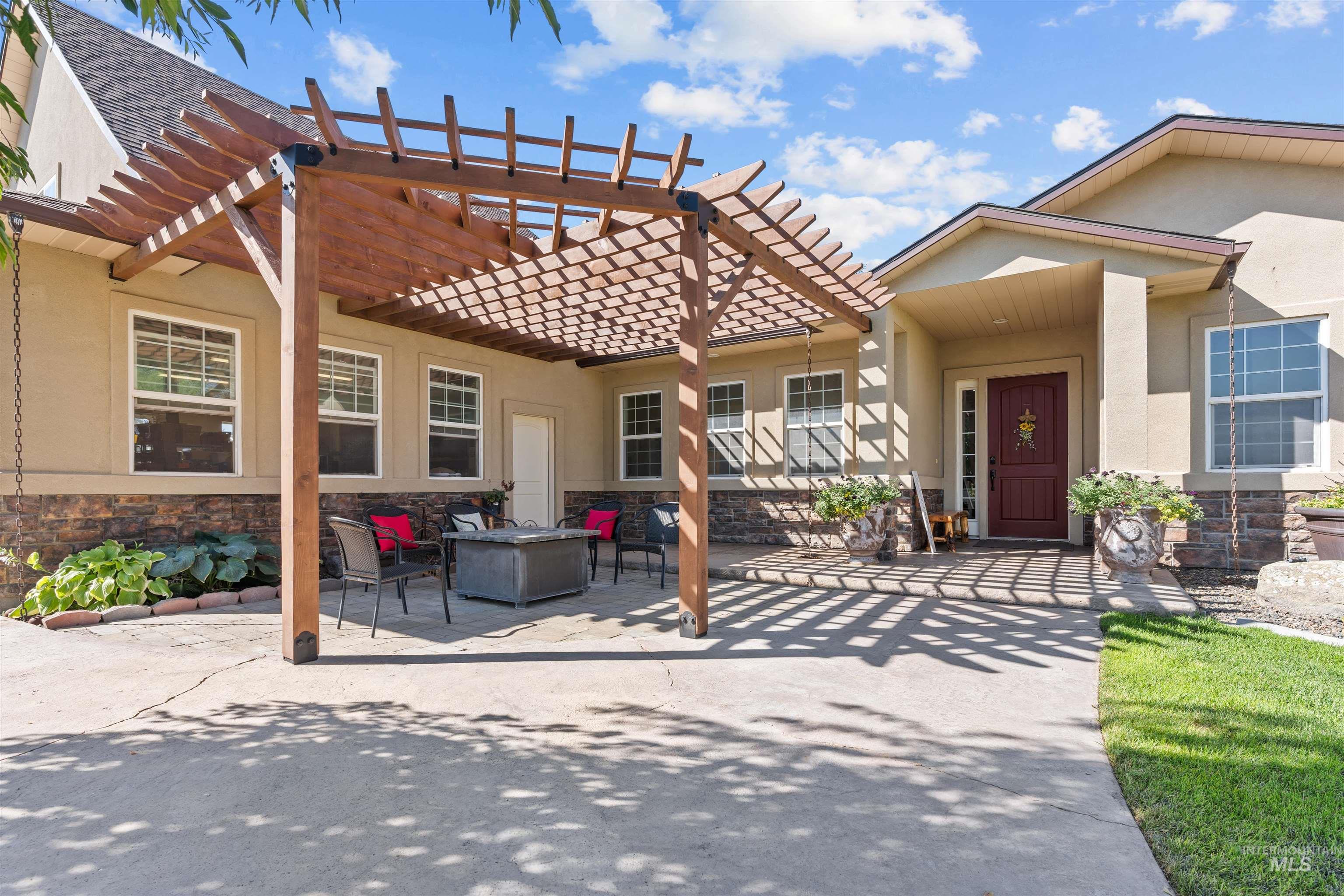 View of patio / terrace with a pergola and a fire pit
